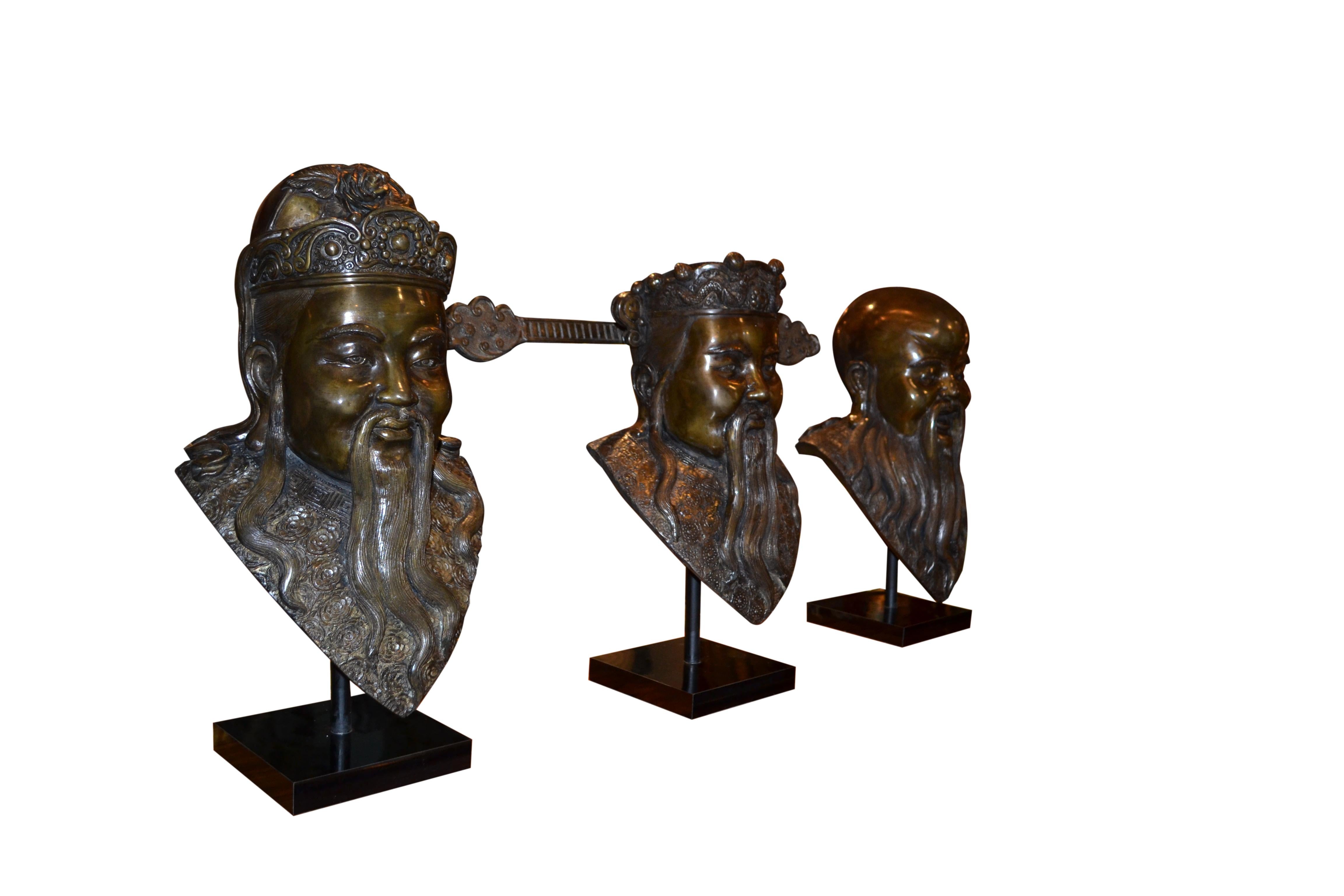  A  rare complete set of three patinated bronze  busts of  Chinese Deities Fu, Lu, Shou (福禄寿) . three prominent gods that hold significant importance in Chinese culture and belief. The well executed busts are not signed and  are supported by a metal
