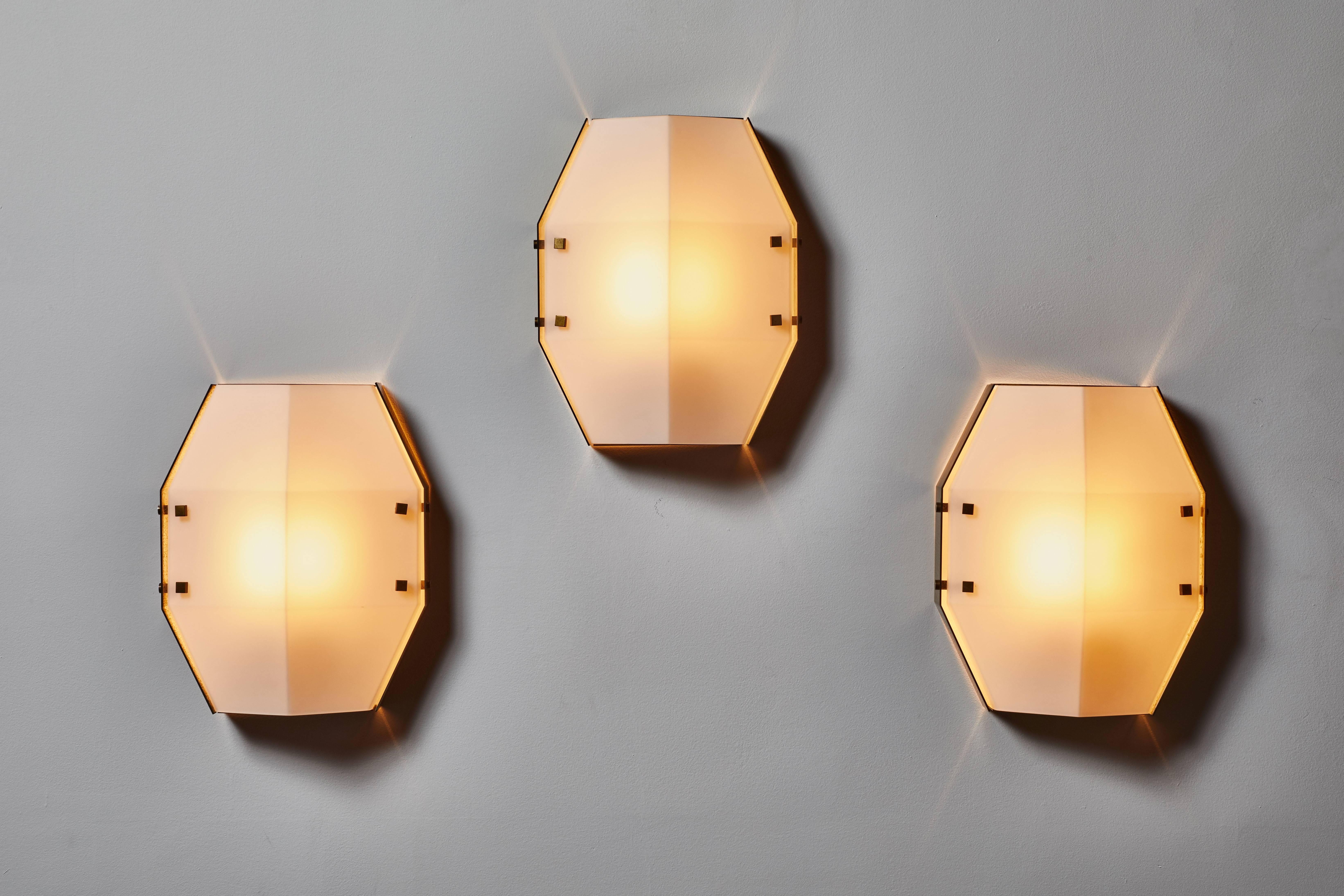 Three rare flush mount wall/ceiling lights by Angelo Lelli for Arredoluce. Designed and manufactured in Italy, circa 1960s. Brushed satin glass, brass hardware and enameled metal frame. Rewired for US junction boxes. Each light takes one E27 100w