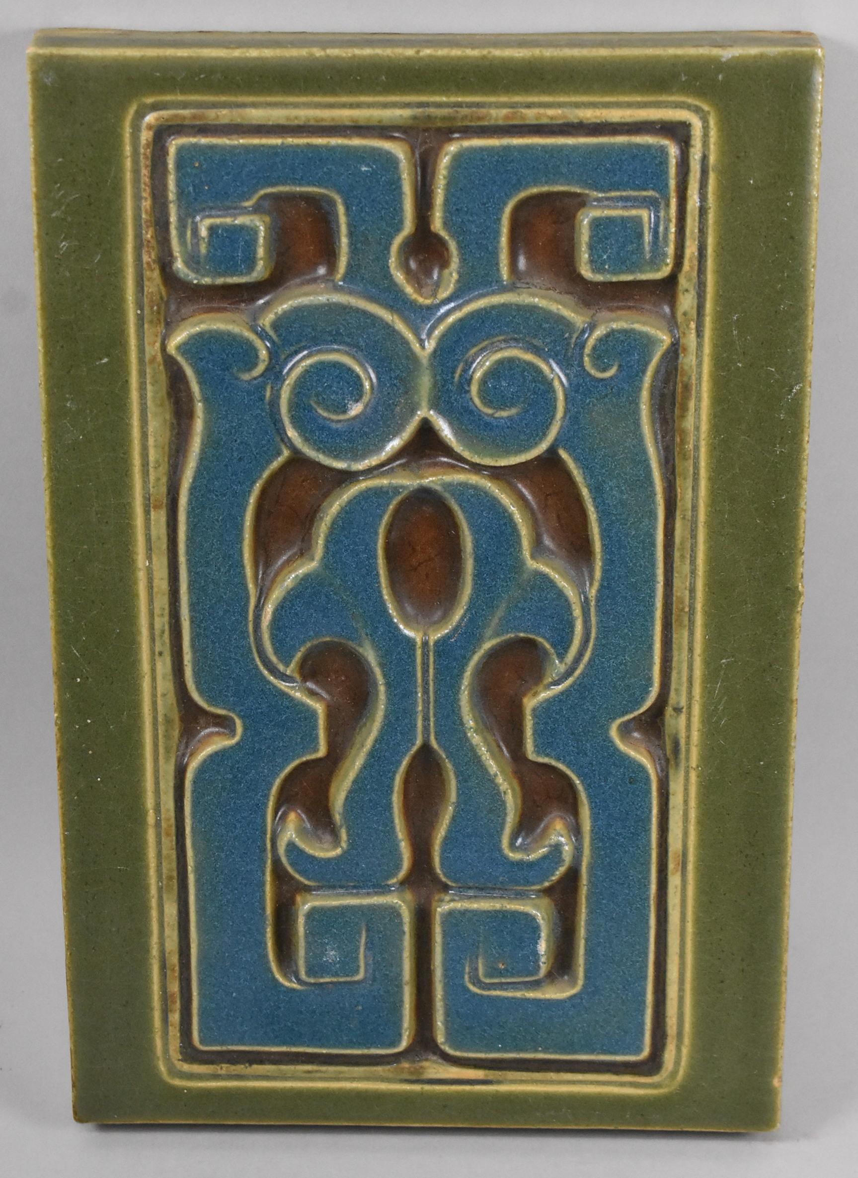 Three Rookwood Pottery Company stylized architectural faience tiles 1987 Y. Minor crazing. One tile has a minute flake on the edge and tiny flakes on some of the raised designs.