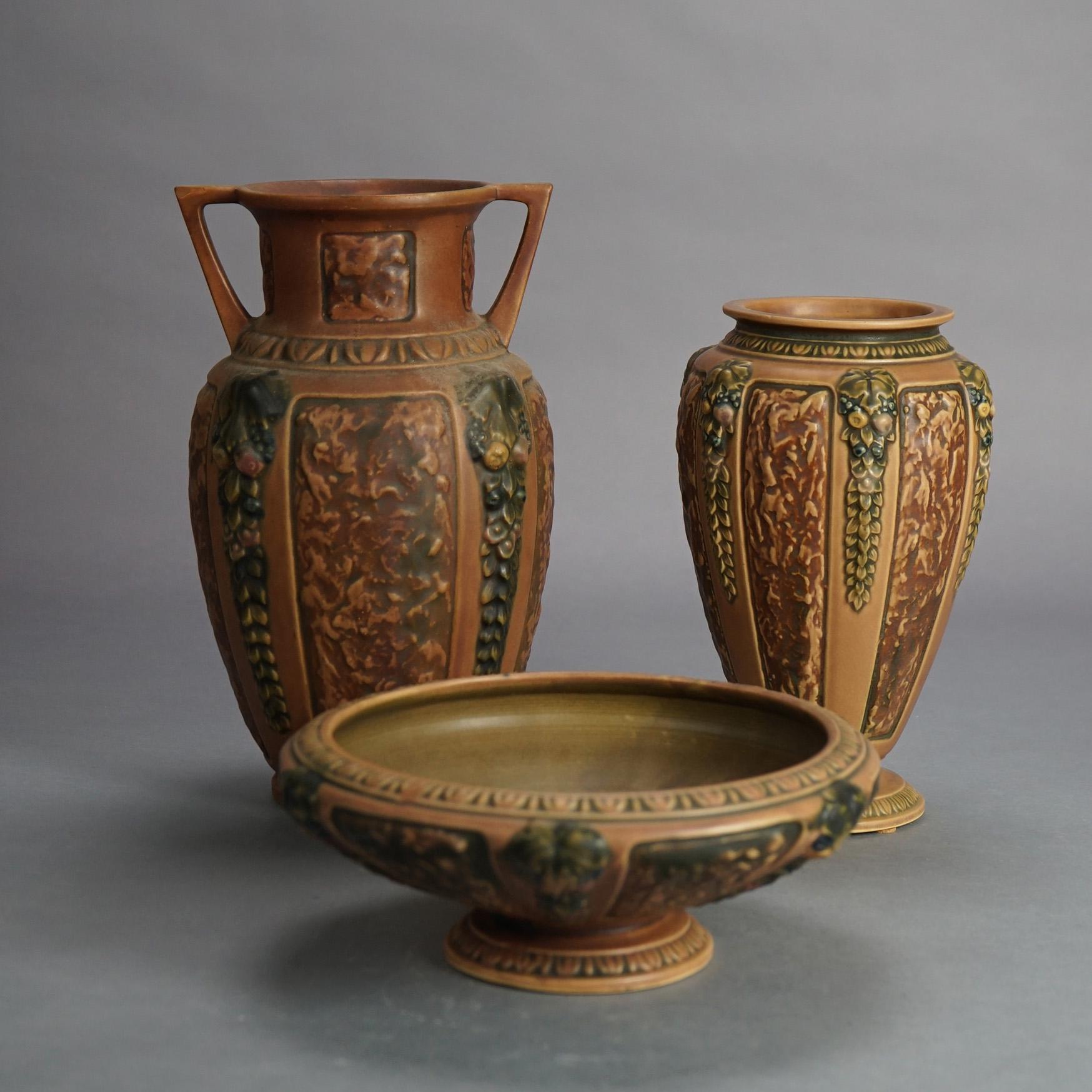 Three pieces of Roseville art pottery of the Florentine line in brown including double handled vase, center bowl and smaller vase, signed, c1924

Measures - 12.5