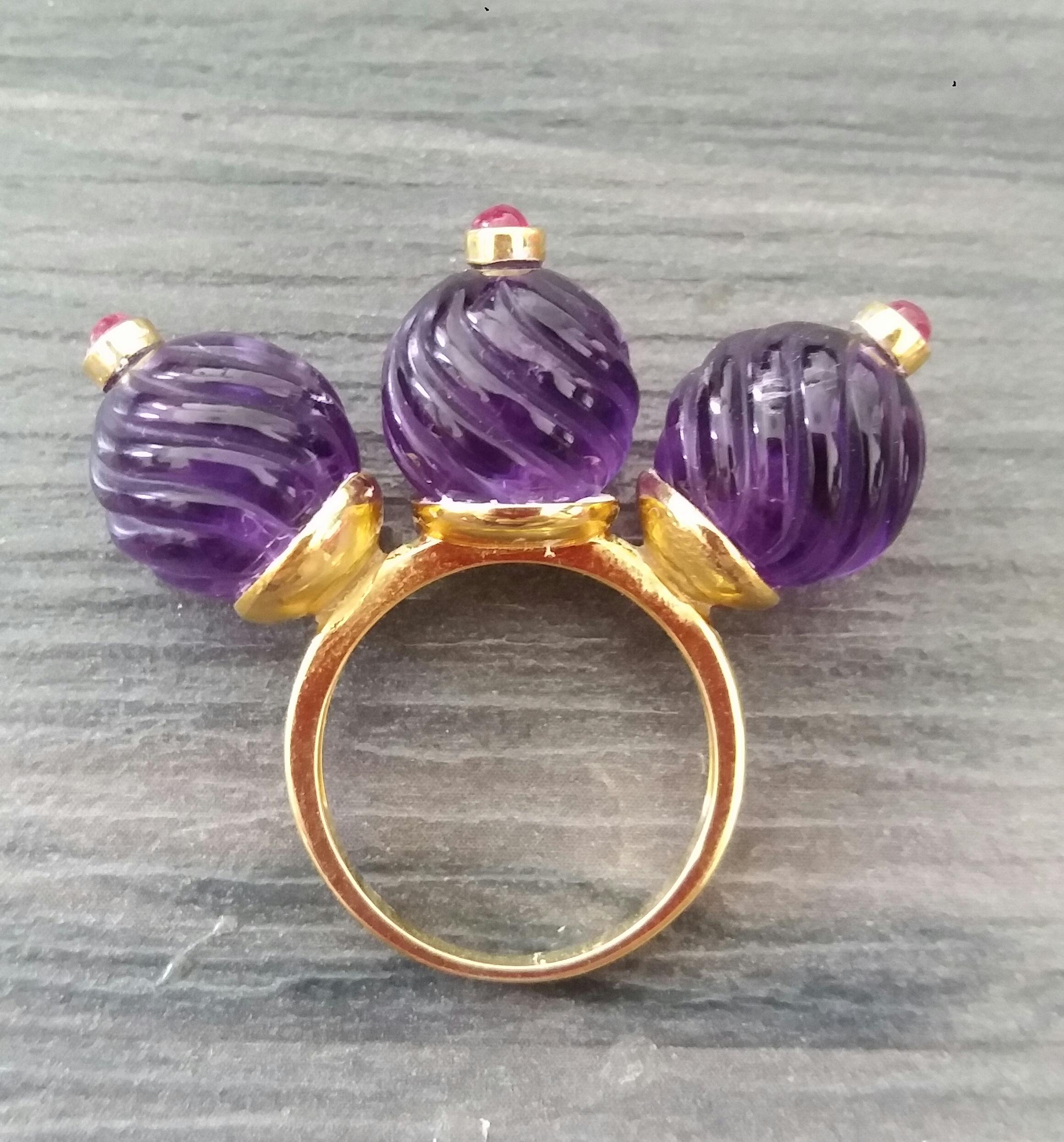 Unique and Classic Cocktail Ring composed of 3 engraved Amethyst spheres of 12 mm. in diameter surmounted by 3 small Ruby cabochons set in yellow gold bezels,all set on a 3 cup yellow gold shank.
In 1978 our workshop started in Italy to make