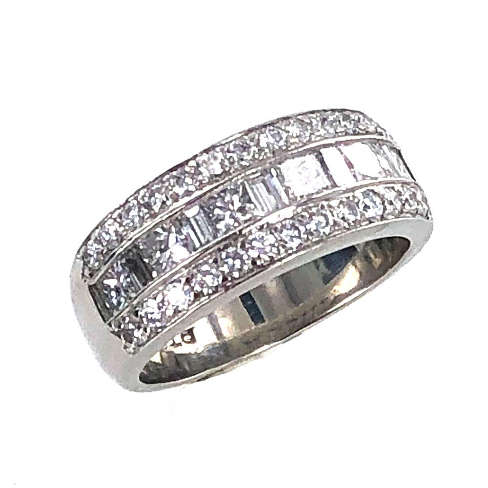 This modern 3 row diamond band was designed by JB Star. The platinum band features three rows of princess cut, baguette, and round brilliant cut diamonds. The diamonds are all graded F-G color and VS clarity. The band measures  8mm in width, and is