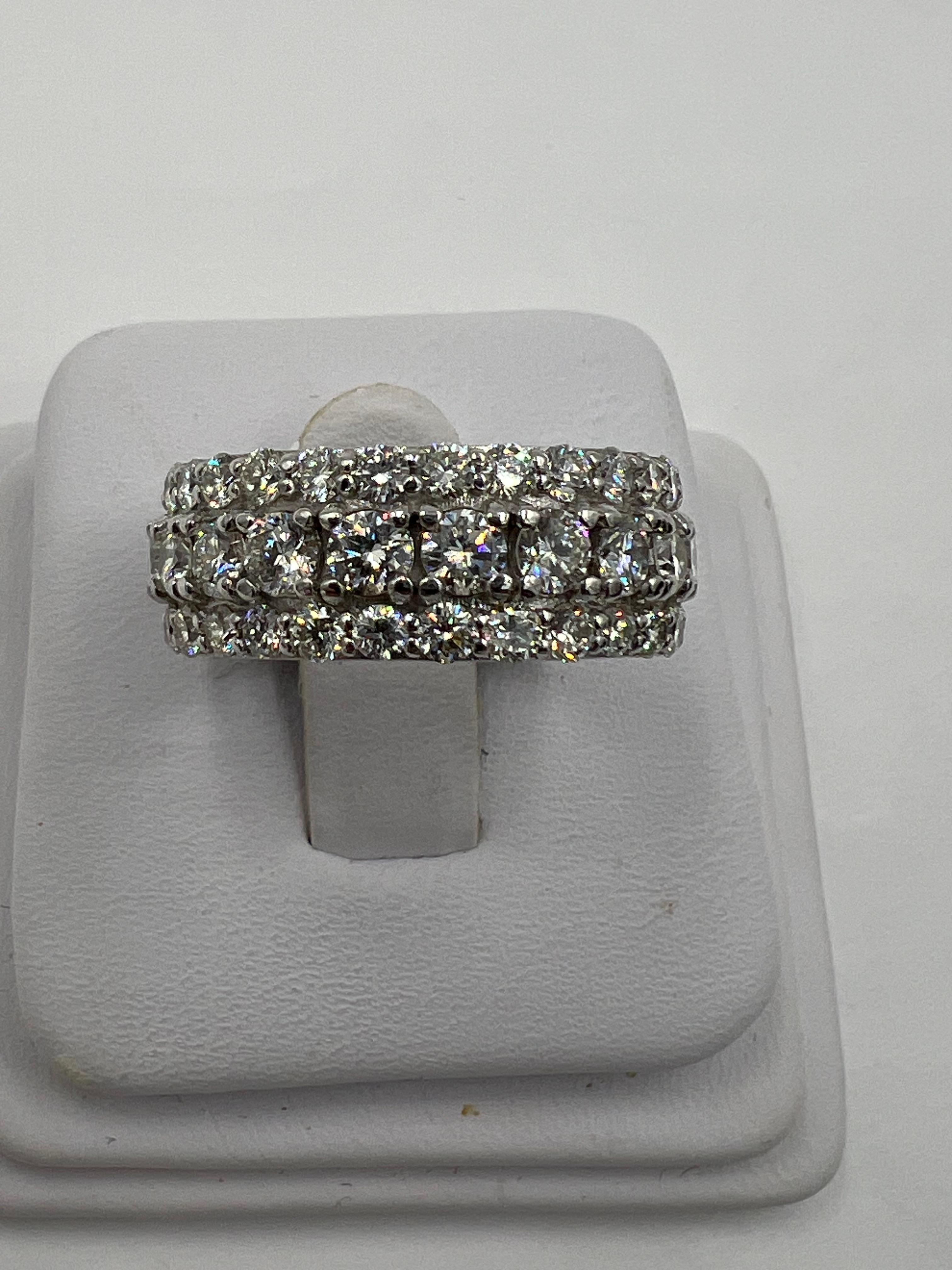 Three row diamond and white gold eternity band ring, size 9.25

This three row diamond white gold eternity ring is the epitome of elegance and sophistication. With its stunning design featuring three rows of sparkling diamonds set in luxurious white