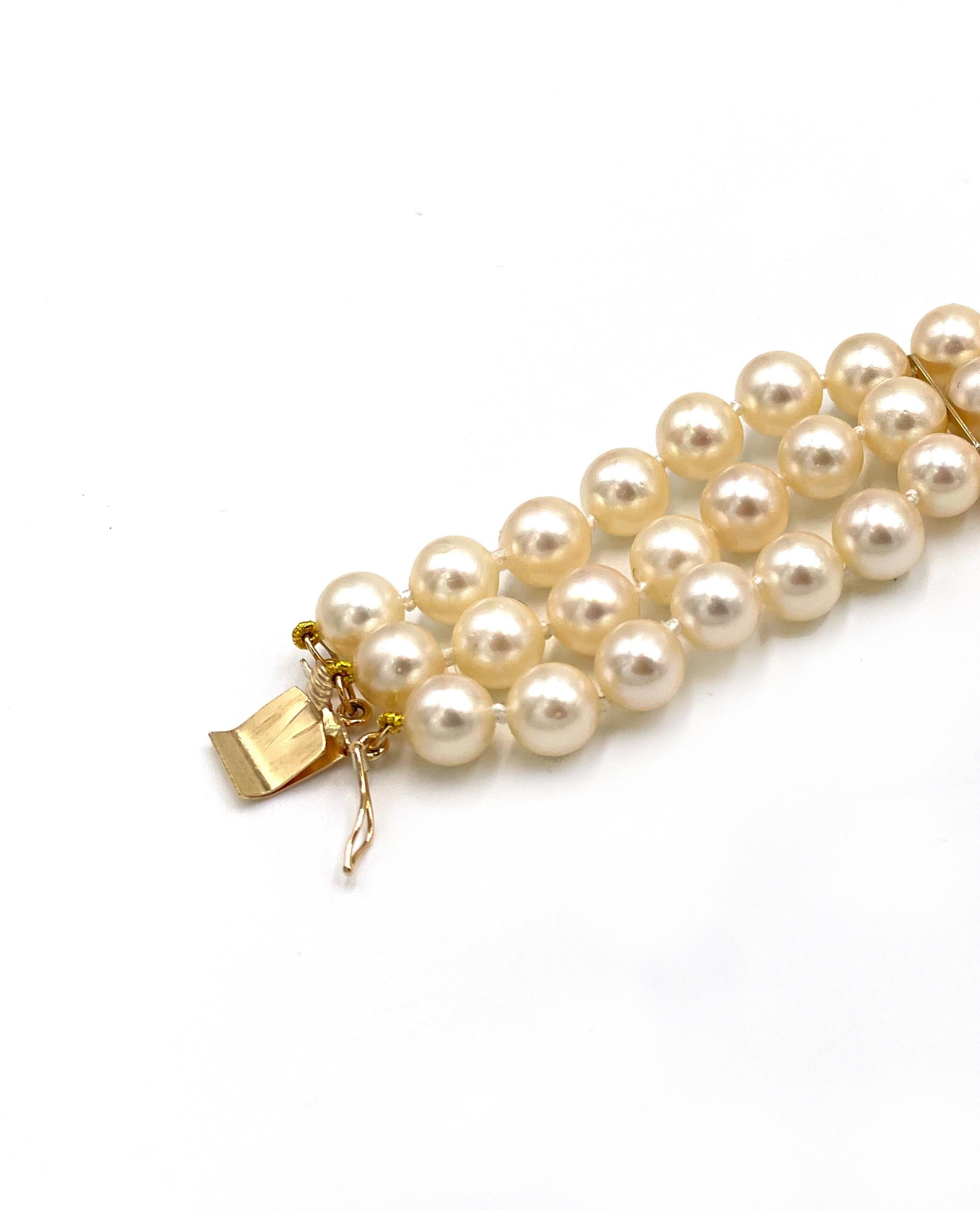 Three row multi strand pearl bracelet with 14K yellow gold spacers and fancy 14K and 18K lock adorned with 0.11 carats natural yellow diamonds and 0.32 carats near colorless diamonds.  The pearls are on average 6-6.5mm. The bracelet also has a