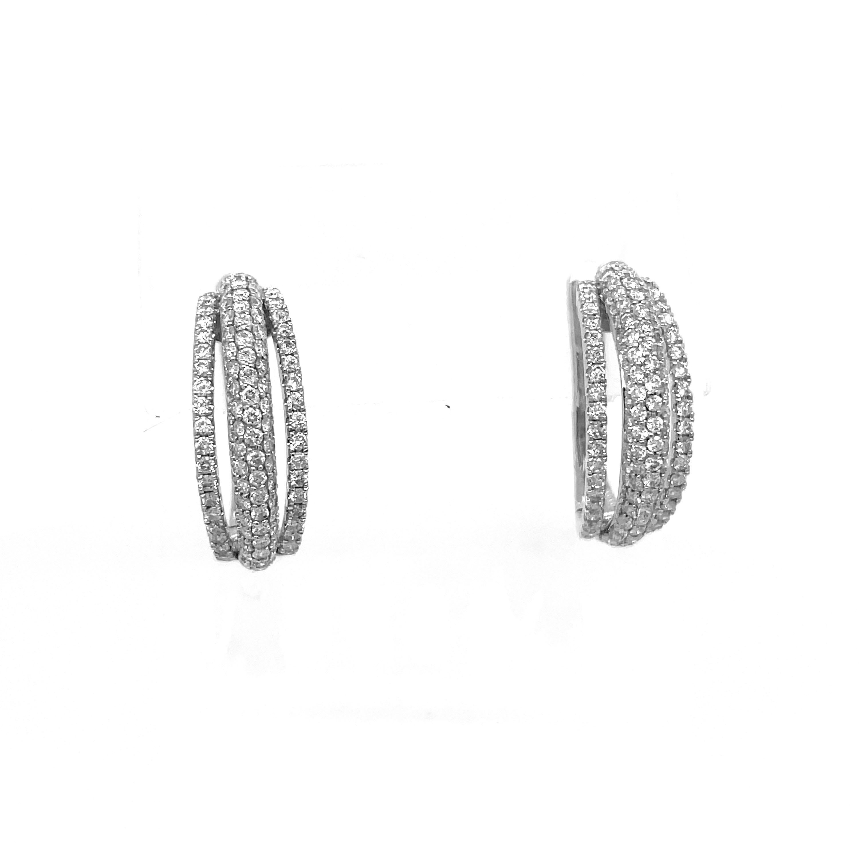This is an exquisite pair of diamond hoop earrings with a three-row pave design encased in 18K white gold. Diamonds are a girl's best friend and this pair of diamond-studded earrings would make a beautiful addition to your jewelry collection. This