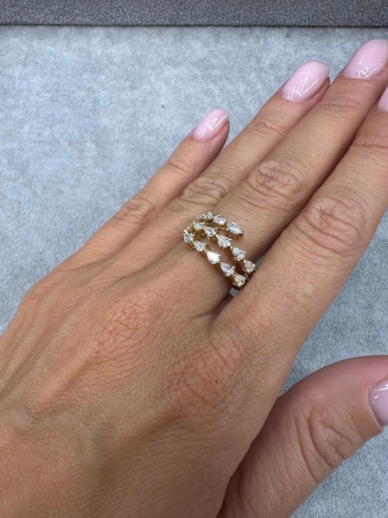 18 Karat yellow gold fashion band ring featuring 17 Pear shape diamonds weighing 1.36 Carats. Color F-G Clarity VS1
Size 6.5
10.3 MM High 

More Fashion Rings in Stock.
Message for Pictures & Details. 