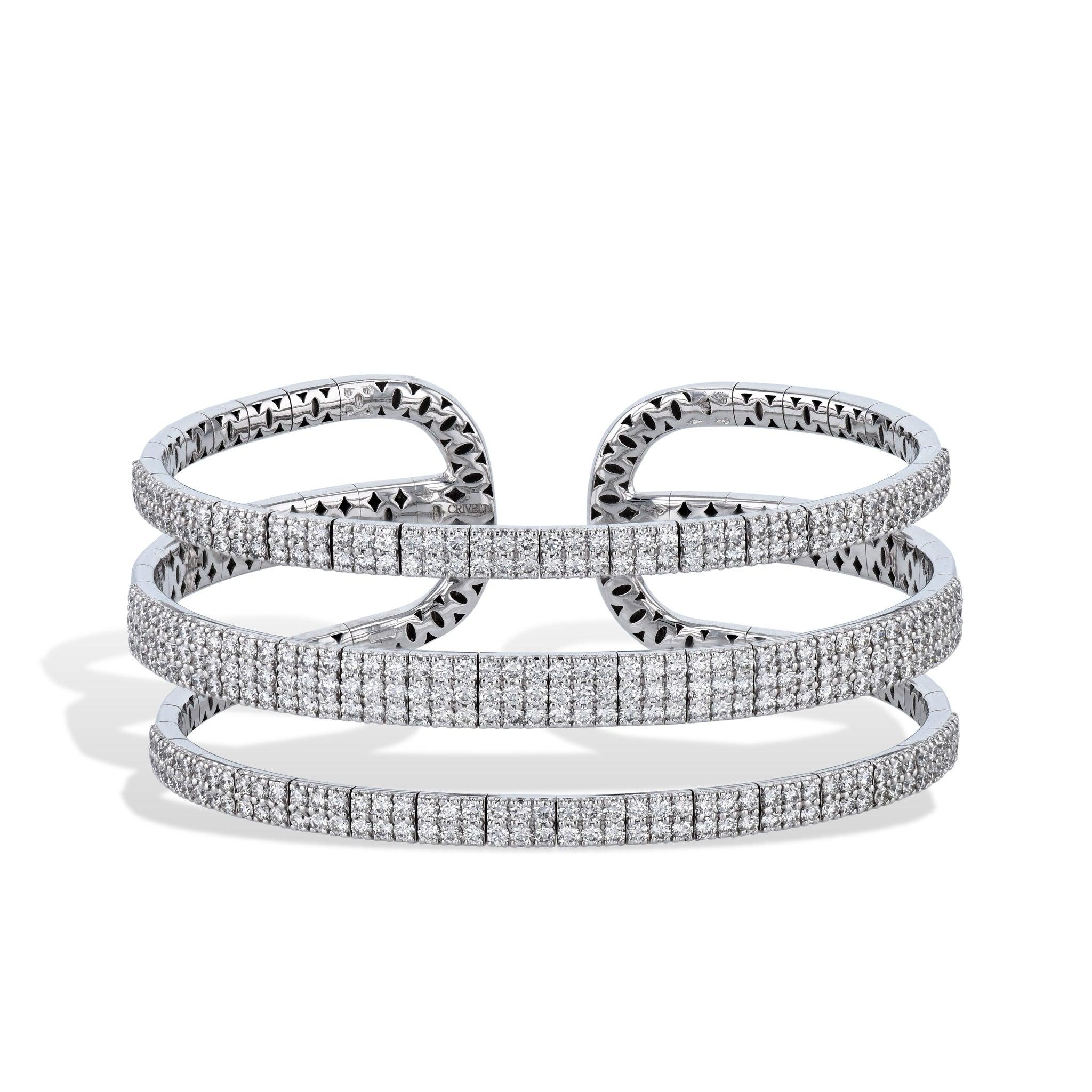 This stunning Three Row White Gold  Pave Diamond Cuff Bracelet features 5.88ct TW F-SI diamonds in an 18kt white gold setting for a luxurious look.
Three Row White Gold Diamond Cuff Bracelet.
Diamond Pave.

5.88ct TW F-SI diamonds.
18kt White gold.

