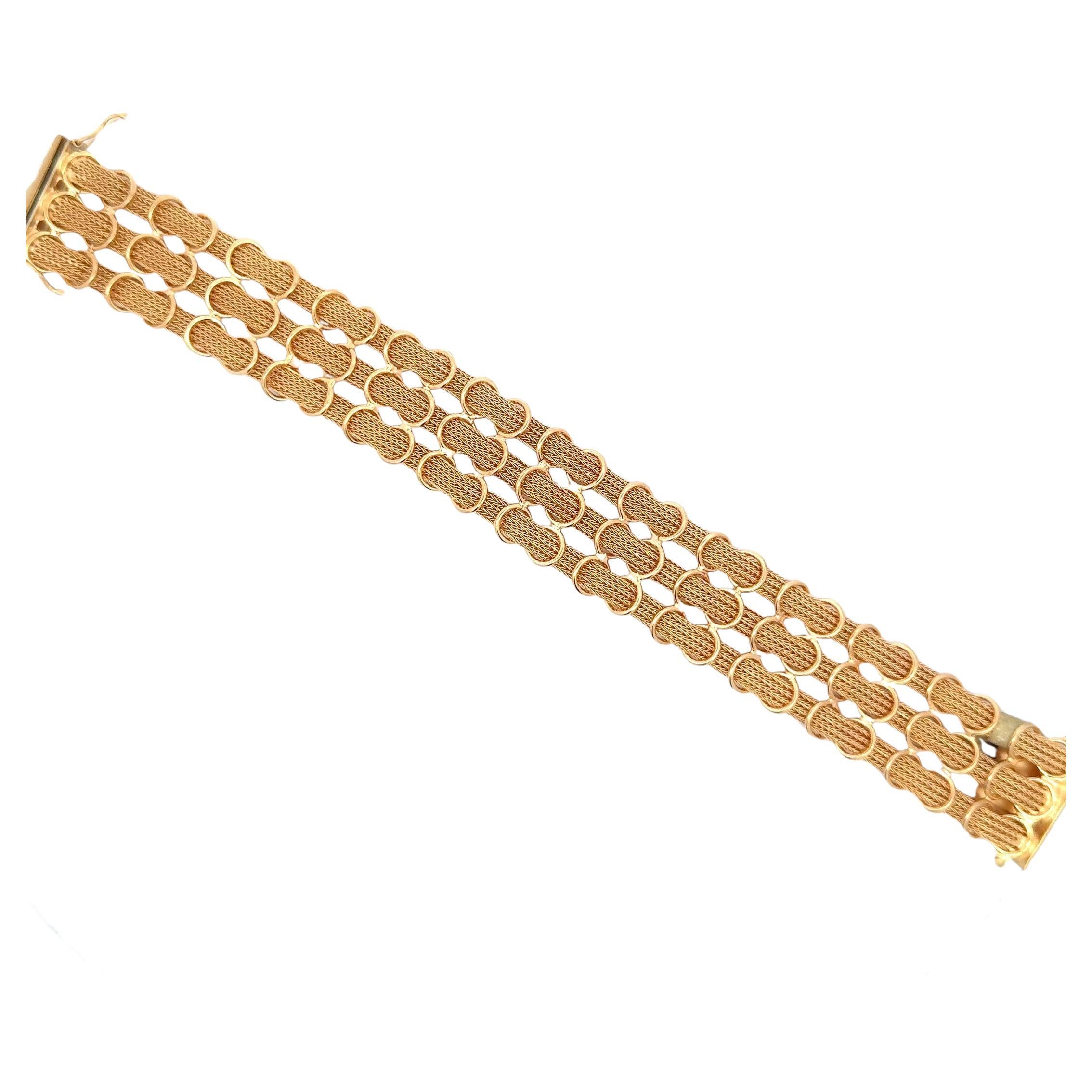 Three row woven net mesh bracelet weighing 41.2 grams in 18 karat yellow gold. 
