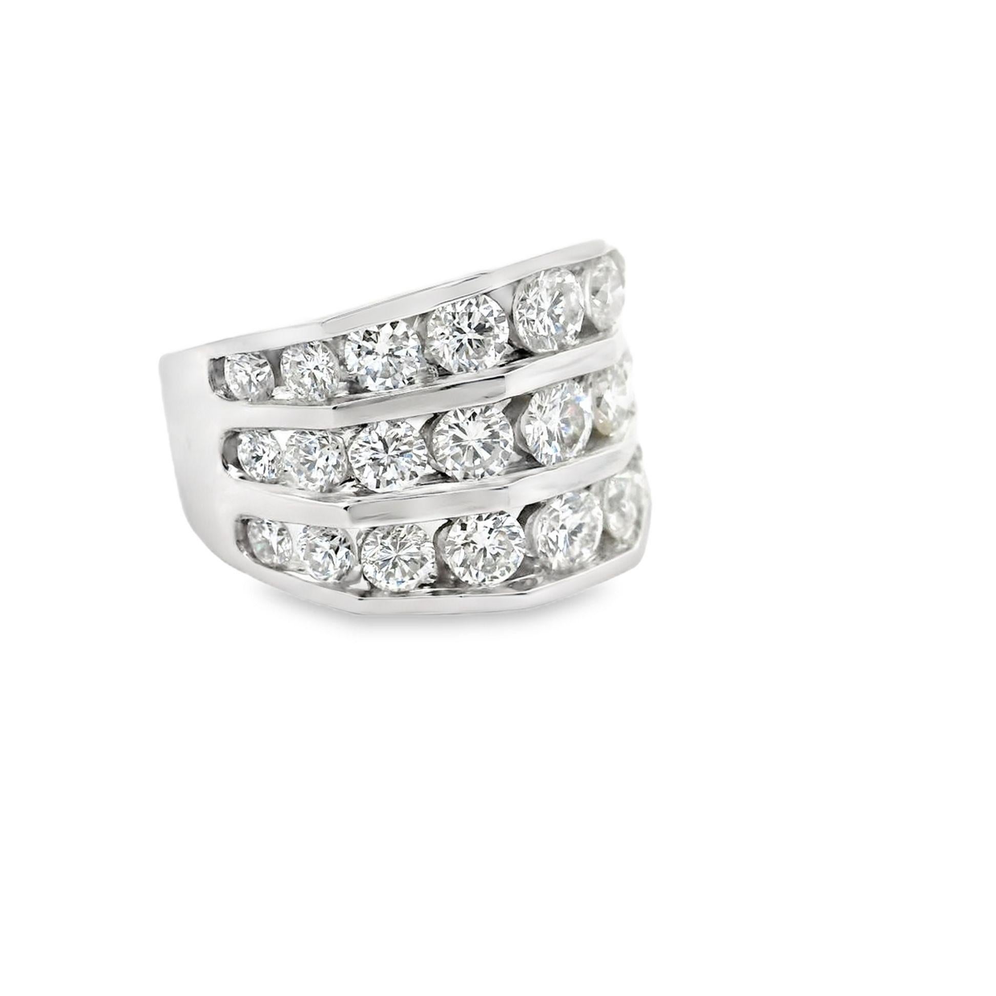 A contemporary fashion ring crafted in 14k white gold, featuring 3 carats of round brilliant-cut white diamonds. The diamonds are arranged in three rows and graduating in size, creating a bold and striking design. This piece exemplifies modern