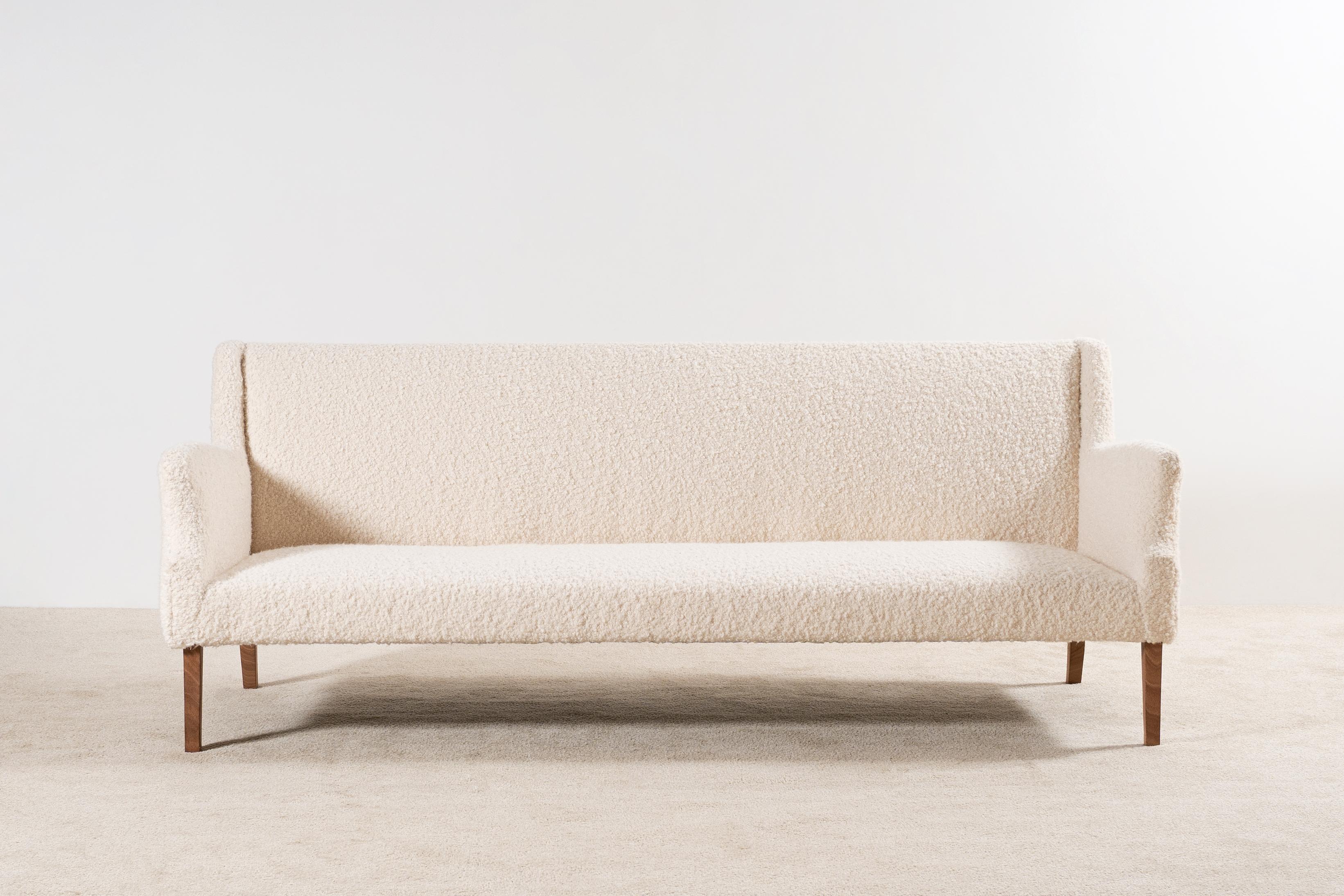 This three-seat sofa is an original piece from the 1960s, manufactured in Denmark.
Beech wood natural color waxed feet.

This sofa has been fully restored and newly upholstered in the traditional way by the best French craftsmen, we used a high