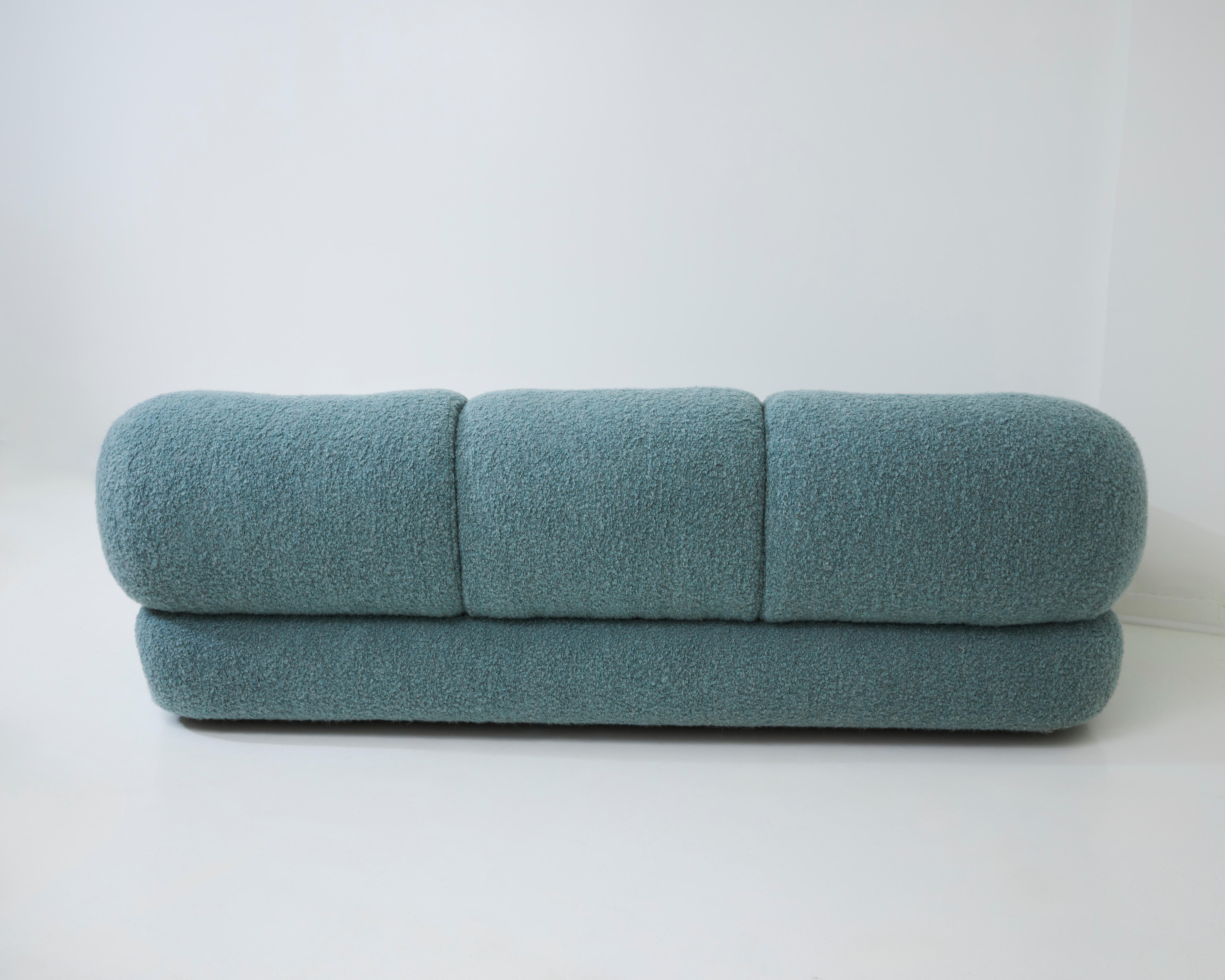 A spacious lounge sofa designed by Sapporo for Mobil Girgi in Italy during the 1970s. This large and stylish sofa boasts fluffy cushions and inviting round shapes that beckon you to sit back and unwind. Designed with comfort in mind, it features