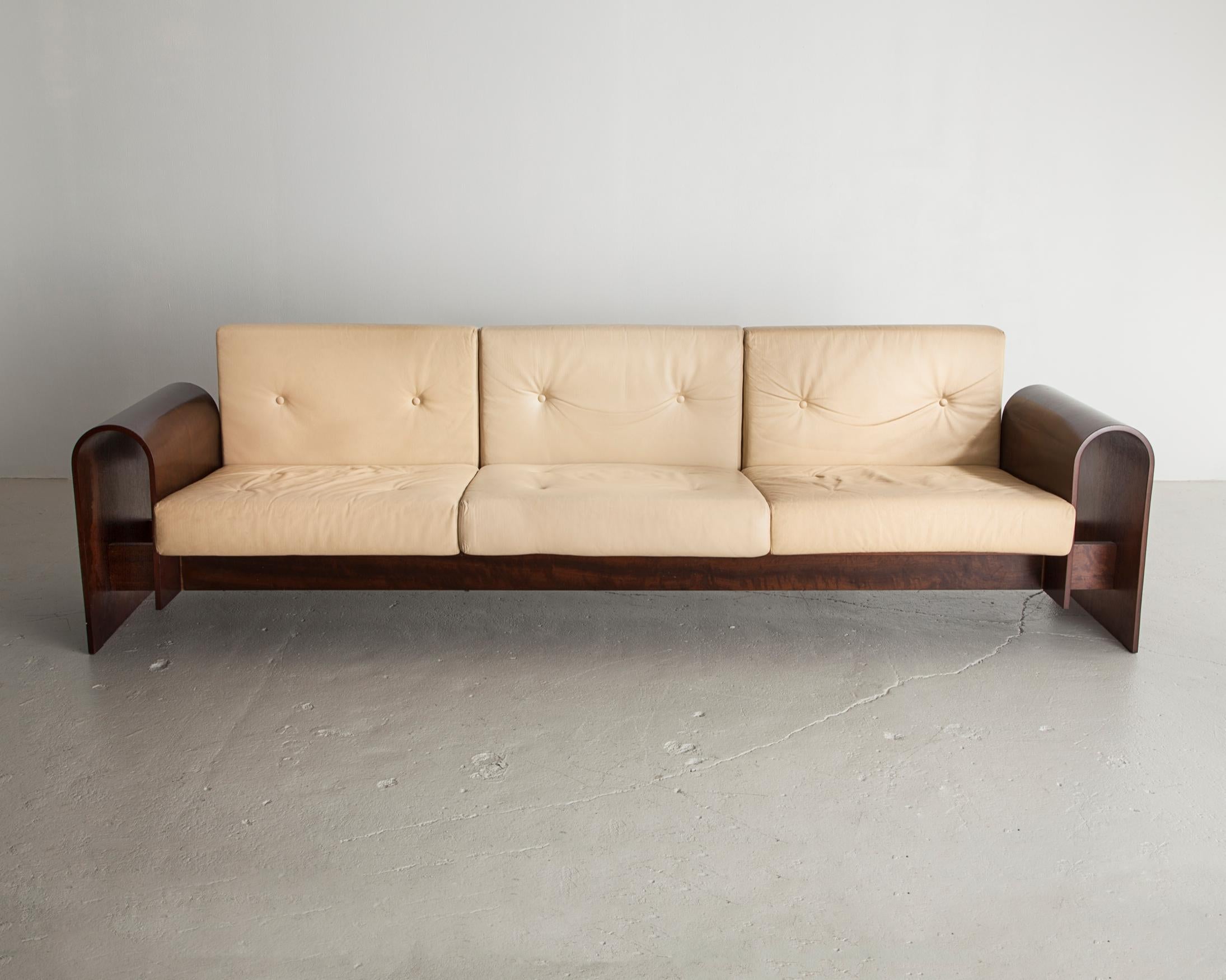 Three-seat sofa in rosewood veneer with upholstered cushions. Designed by Oscar Niemeyer for the SESC hotel, Brazil, 1990.