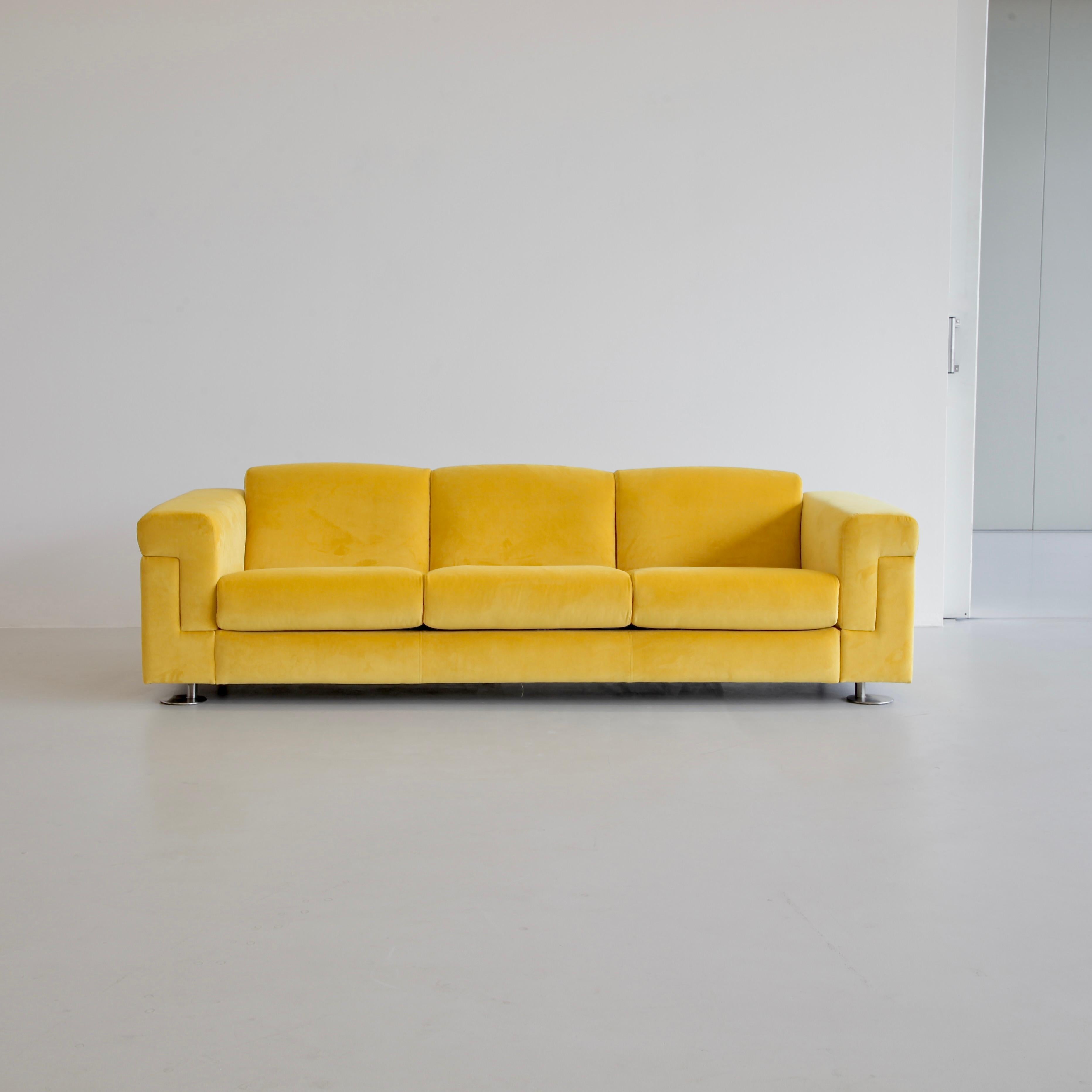 Three seat sofa designed by Valeria Borsani and Alfredo Bonetti. Italy, Tecno, 1966.

Large sofa upholstered in yellow velvet designed by Tecno's Borsani and Bonetti in 1966. Polished metal feet appear retracted inwards with respect to the centre of