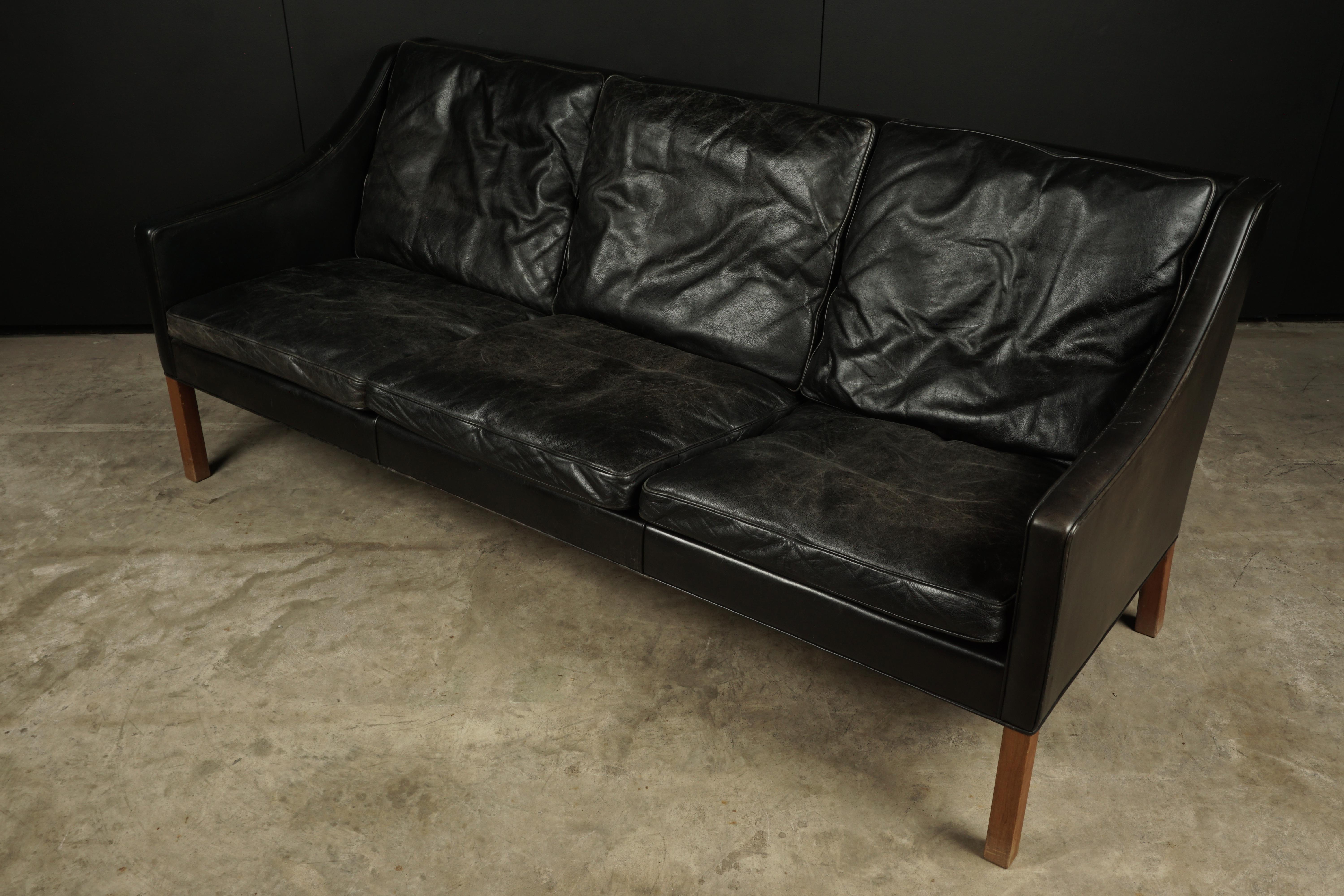 Three-seat sofa designed by Borge Mogensen, Model 2209. Original black leather upholstery with nice wear and patina.