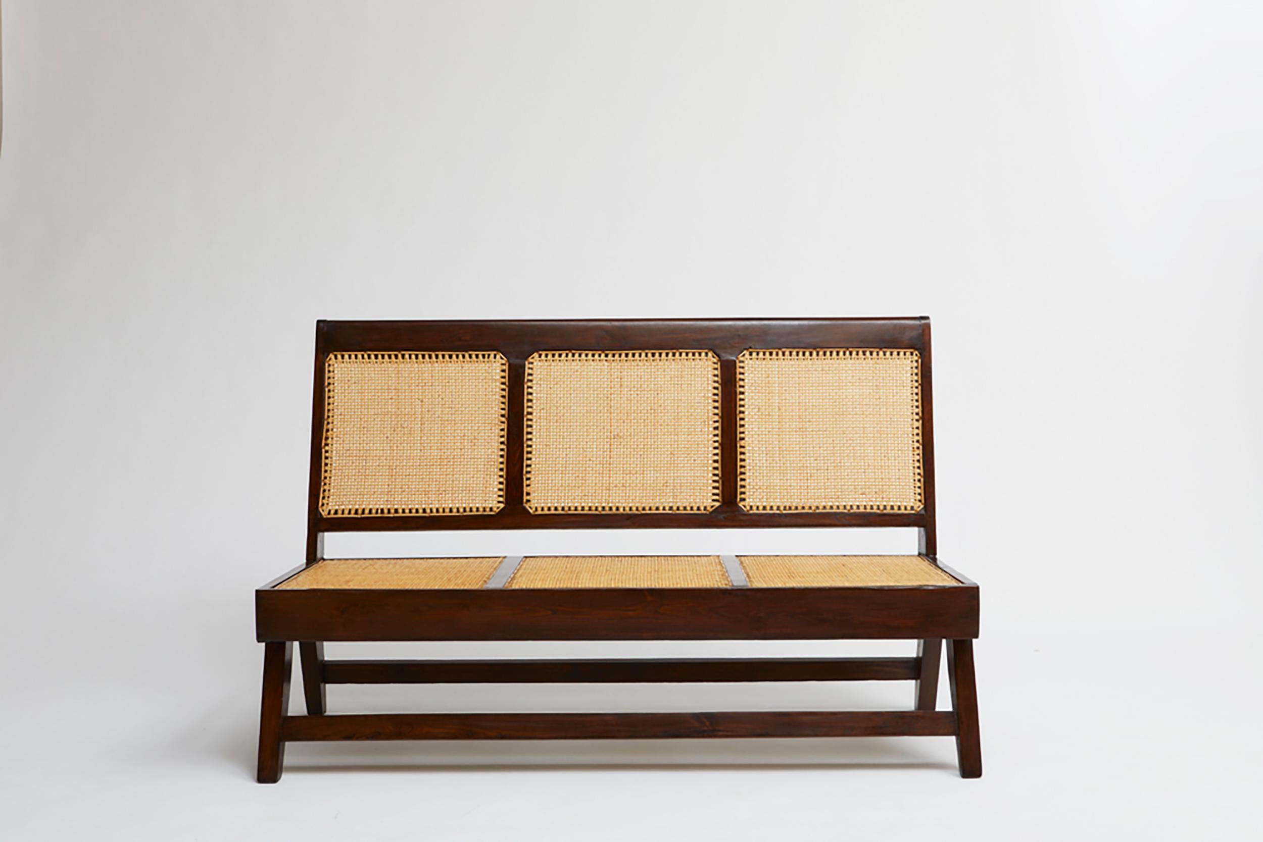 This three seat sofa is by Pierre Jeanneret circa 1955-56. It is made from teak and woven cane and originally designed for Jeanneret's project in Chandigarh, India.
