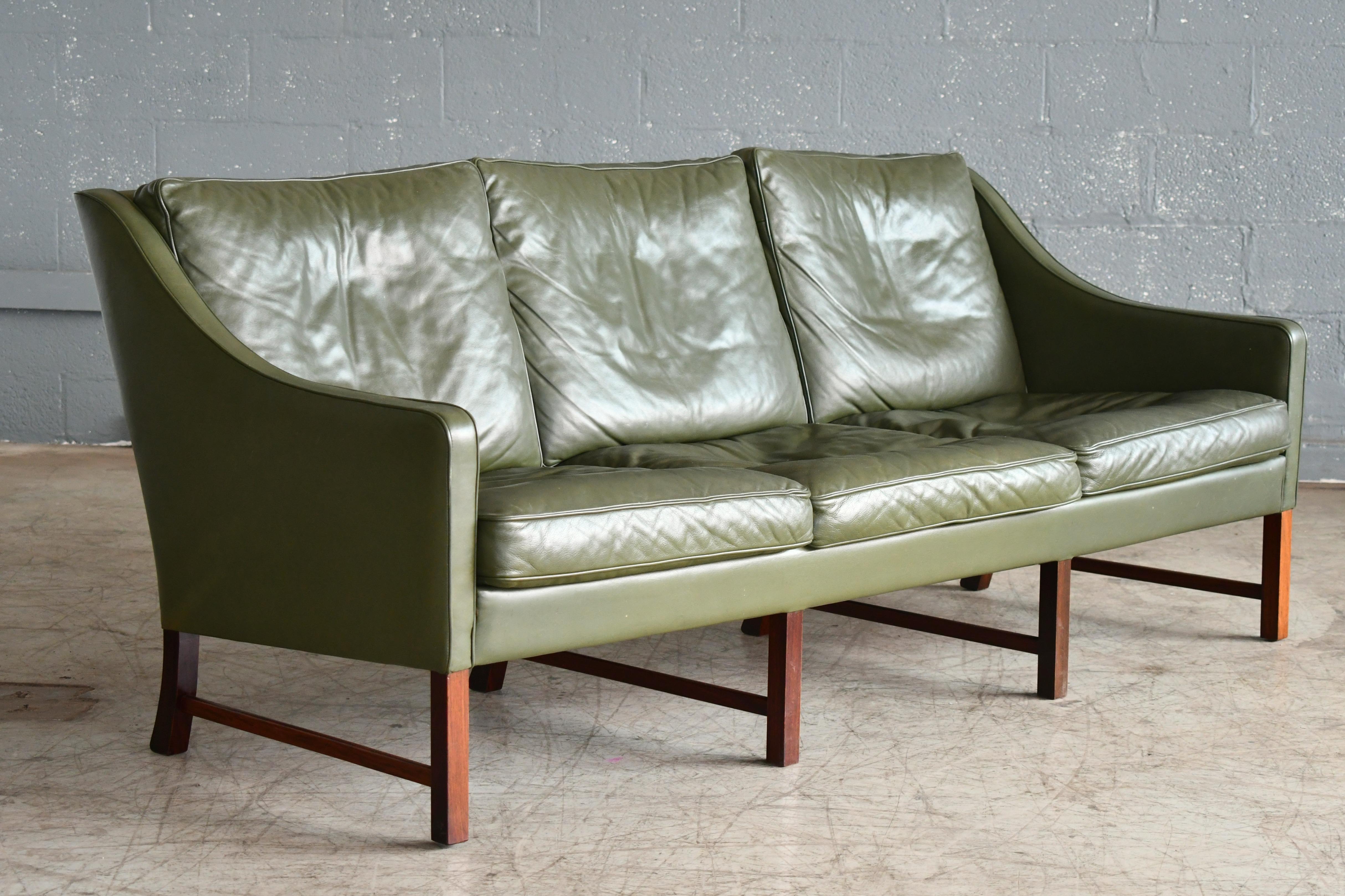 This very elegant and generously sized three-seat sofa is unmarked but in terms of design bears many of the hallmarks of one of Norway's most iconic designers, Fredrik A. Kayser. This sofa resembles Kayser's model 965 made by Vatne but with a