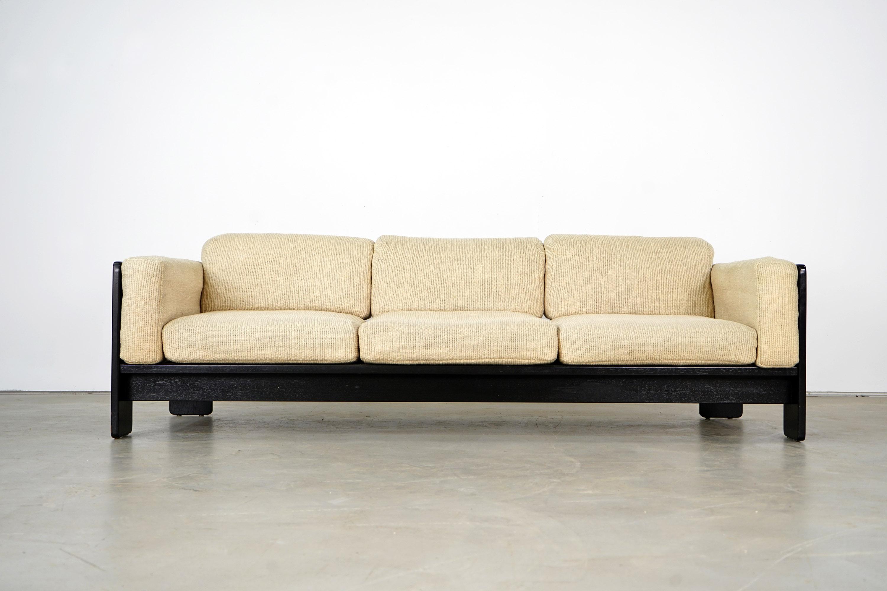 Three-seat sofa from the Bastiano series by Tobia and Afra Scarpa. The piece has a black ebonized oak frame and original sand-colored pillowcases. The upholstery has been renewed. Accordingly, the piece is in an excellent vintage condition with