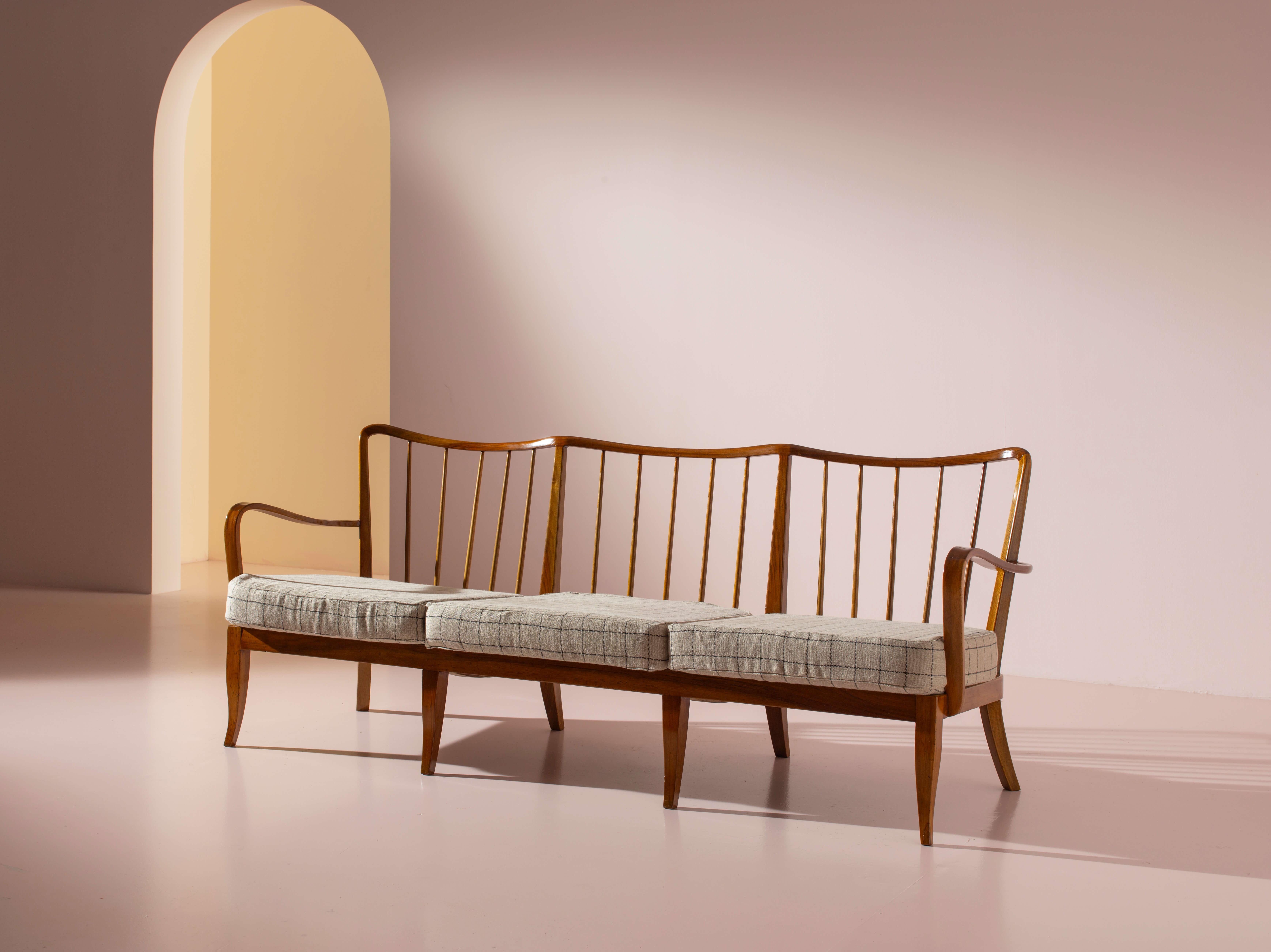 A three-seater sofa in walnut and fabric, in the style of Paolo Buffa, Italian manufacture, 1940s

Graceful, sinuous curves define this Italian three-seater sofa from the 1940s. Crafted with exceptional artisanal skill, the wooden structure reflects