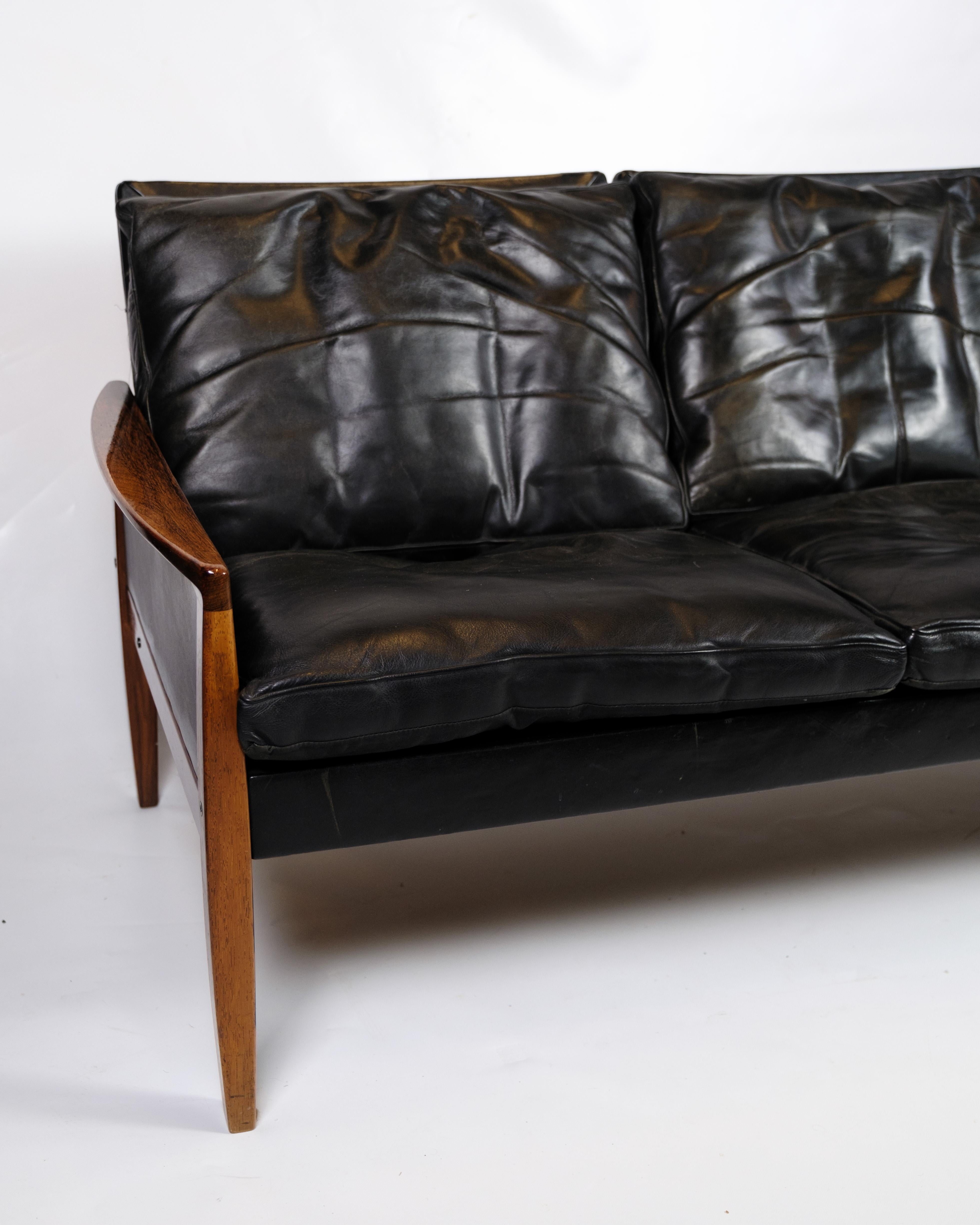 This elegant 3-seater sofa combines luxury with comfort and functionality. Crafted from solid rosewood and upholstered with black leather cushions, this sofa offers a sophisticated and comfortable seating experience. Its beautiful silhouette and