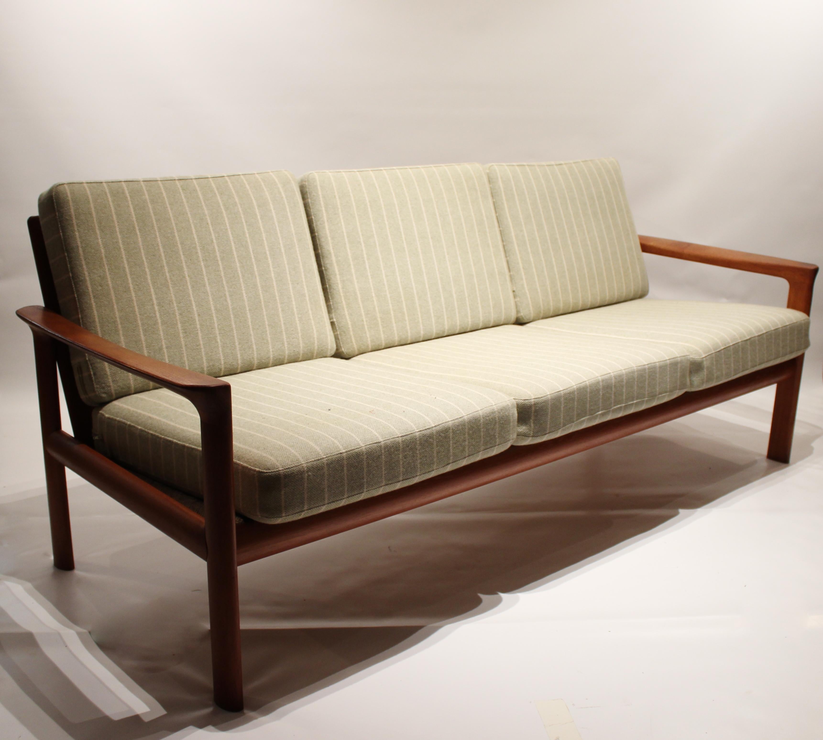 Three-seat sofa of teak and cushions upholstered in light green wool fabric designed by Svend Ellekær and manufactured by Komfort in the 1970s. The sofa is in great vintage condition.