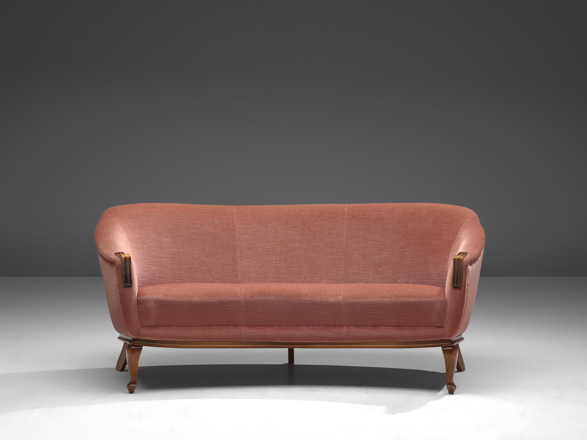 Three-seat sofa, velvet and oak, Denmark, 1940s

This curved three-seat sofa with soft pink sofa shows characteristics of late art deco and start of Scandinavian Modern. The sofa is slightly curved which is emphasized by the high, smooth backrest