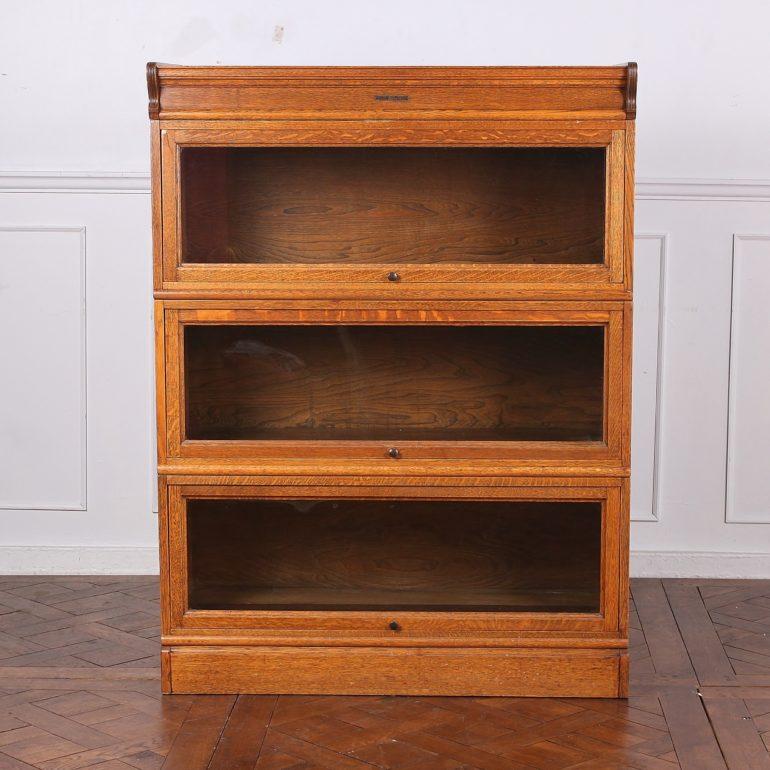 A three-tier set of lawyers bookcases, American made by Vetter Desk Works of Rochester, New York; quarter-sawn solid oak, with panelled sides.



   