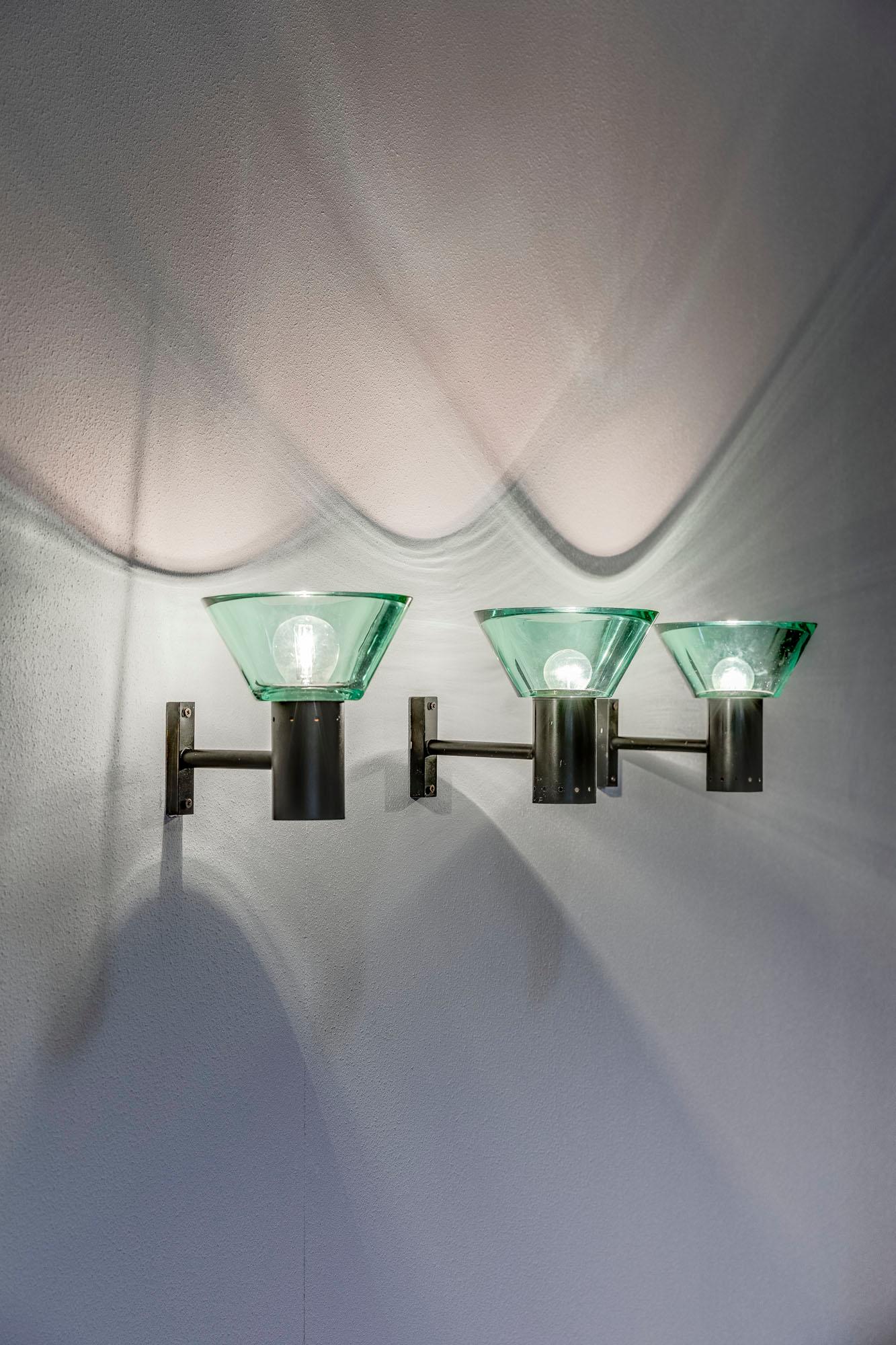 Three wall lights by Seguso.
One support is little bit different as you can see in the pictures.
Brass black painted structure, very thick green Seguso glass.

 
