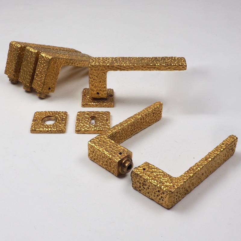 French 1970s gilt door handles.

Three sets of 1970s French lever door handles with six matching key plates and 6 lever handles finely cast with hand-hammered textured gilt finish, stunning in their simplicity.
 