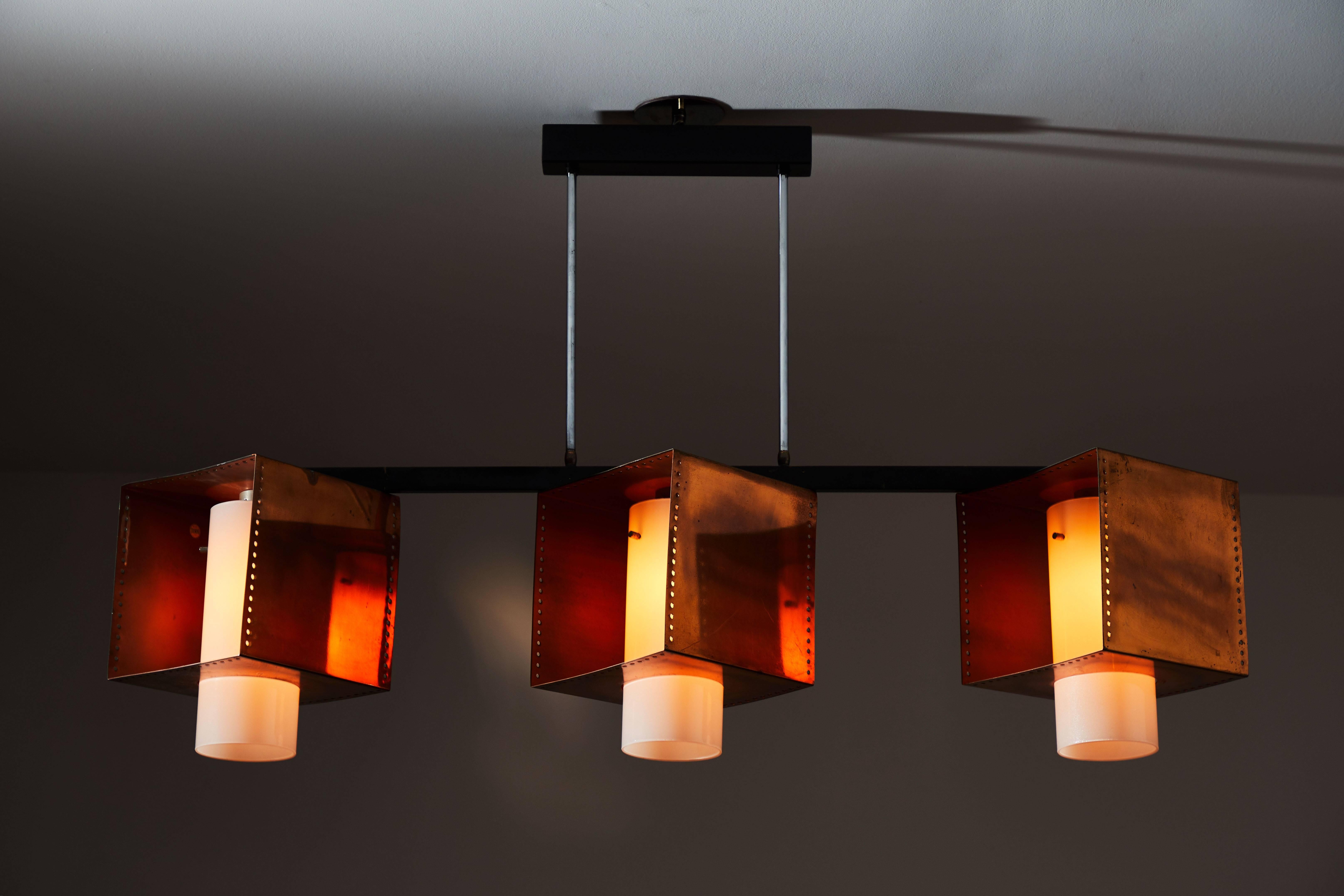 Rare three shade chandelier designed and manufactured by Stilnovo in Italy, circa 1960s. Copper-plated brass, brushed satin glass diffusers and enameled metal hardware. Rewired for US junction boxes. Each shade takes one E27 60w maximum bulb. Each