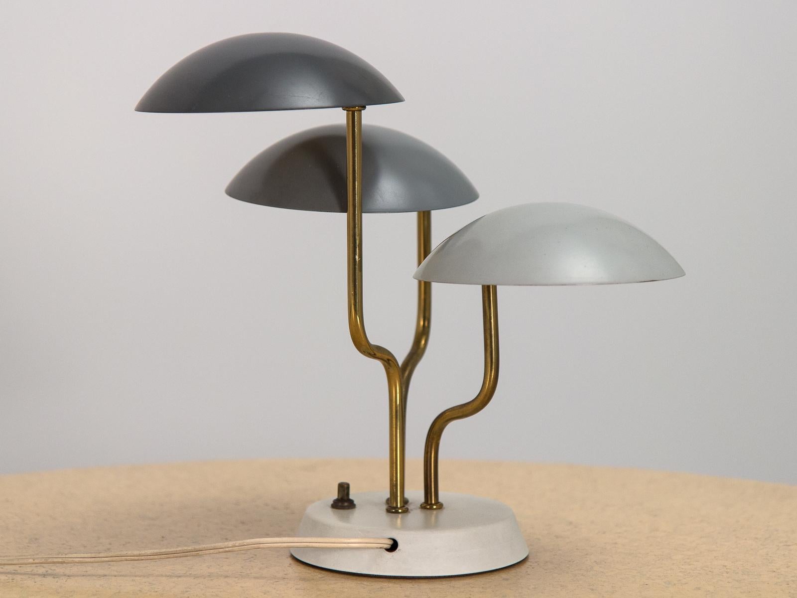 Petite organic modern table lamp, designed by Gino Sarfatti for Knoll. Three domed shades, enameled in graduated gray tones, float on curved brass rods on an ivory base. In wonderful condition, with minimal scratching to the original paint on shades