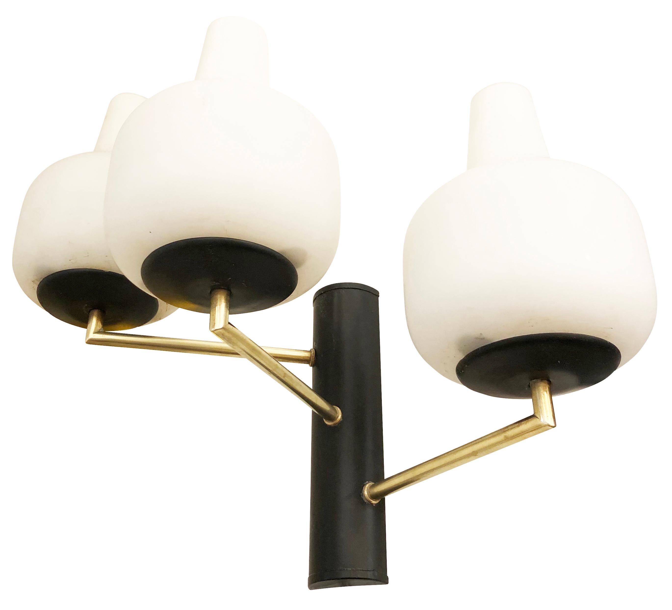 Pair of Stilnovo Style wall lights, each with three staggered frosted glass shades on a brass and black lacquered frame. Three candelabra bulbs per sconce.

Condition: Excellent vintage condition, minor wear consistent with age and use.

Measures: