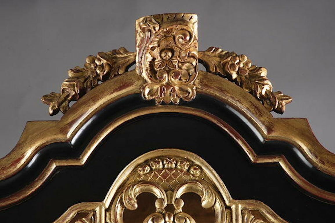 Solid softwood and beechwood, partly ebonized and polished gold-plated. Heavily scalloped, profile-framed, single-section frame base on strong claw feet. Upright rectangular, single-door body. Stepped profile gable. Rocaille cartouche with plastic