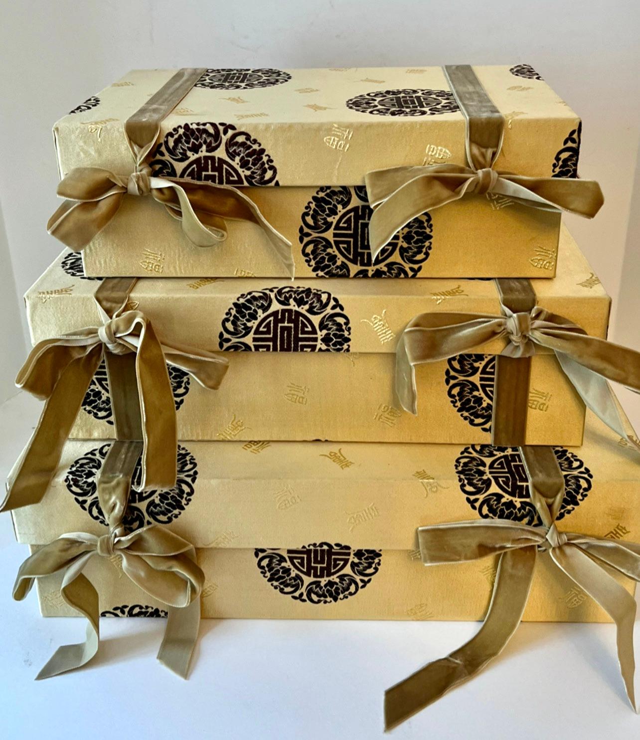 Set of three nesting boxes in Asian Chinese Fabric with symbols for good luck and double happiness.  The boxes fit inside each other as well as have velvet ribbons that tie into a bow.

The boxes are wonderfully decorative and can also store papers,