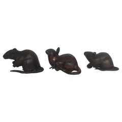 Three small Japanese bronze rats, Meiji Period, two holding chestnuts