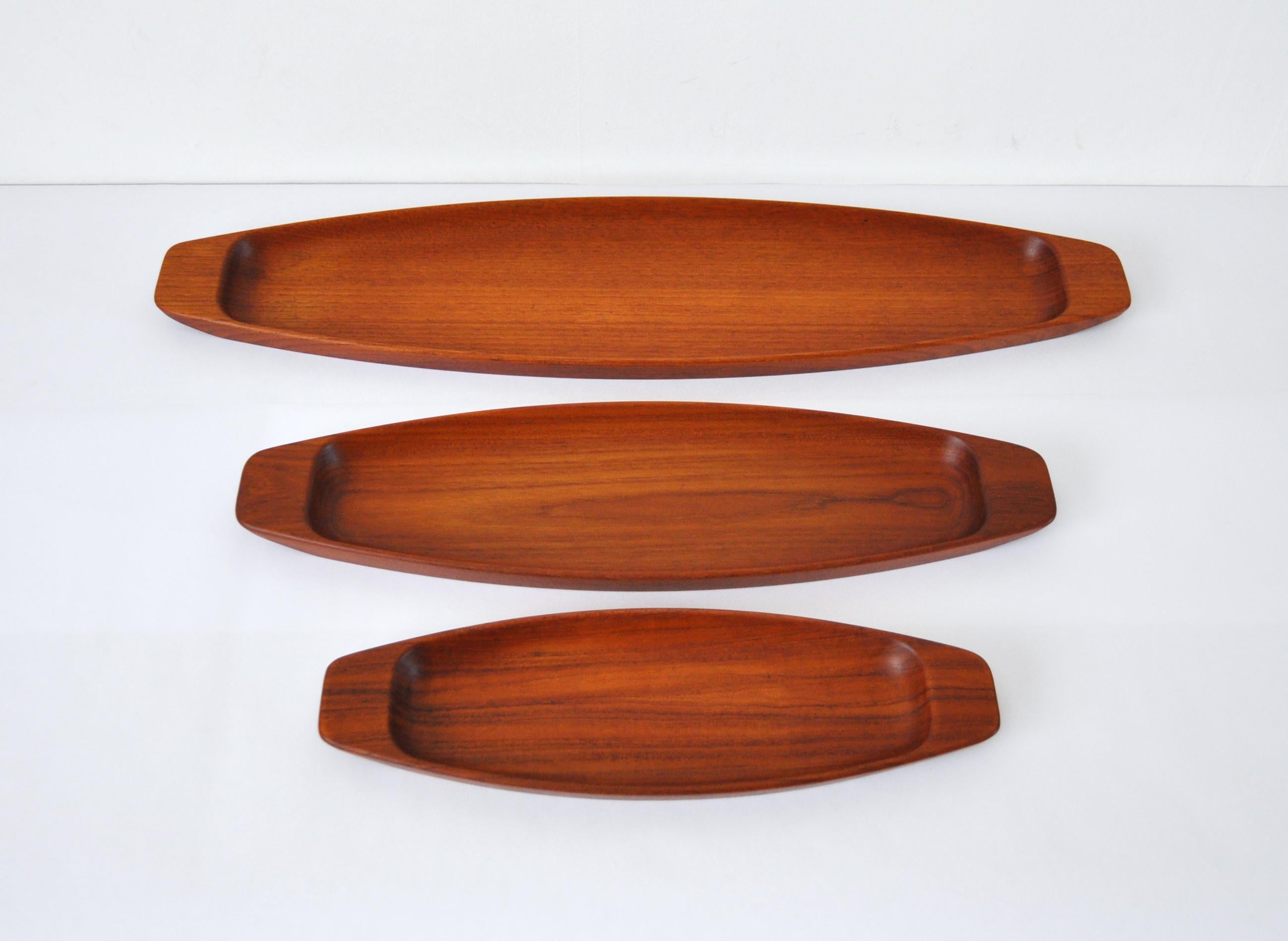 Complete set of three solid teak serving trays by Skjøde Skjern, Denmark 1960s. Designed with a slight size disparity (small, medium, and large) to allow the trays to nest together when not in use.
Very fine vintage condition. 
Measures: 
Small