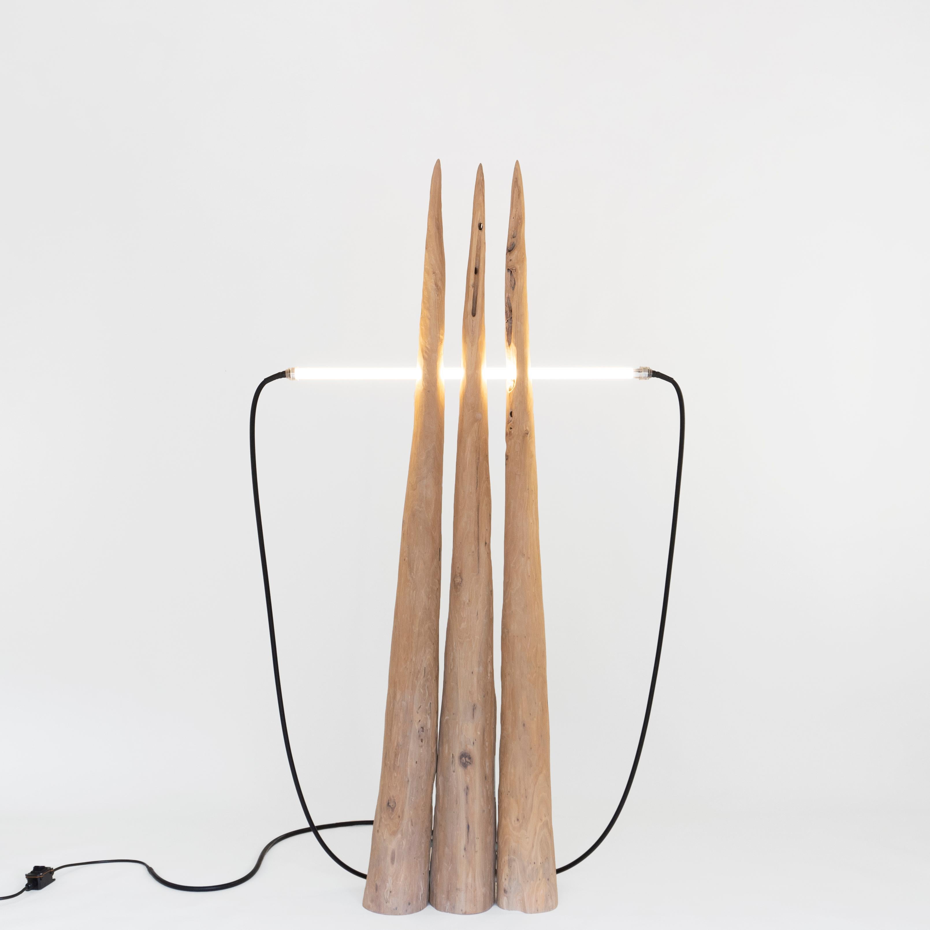 Three Spike Light by Henry D'ath
Dimensions: D 110 x W 20 x H 190 cm
Materials: Wood.
The piece is available in natural, cream lacquer, or black calligraphy ink finish.

Piece is handmade by artist.

Made of three columns of wood from historical