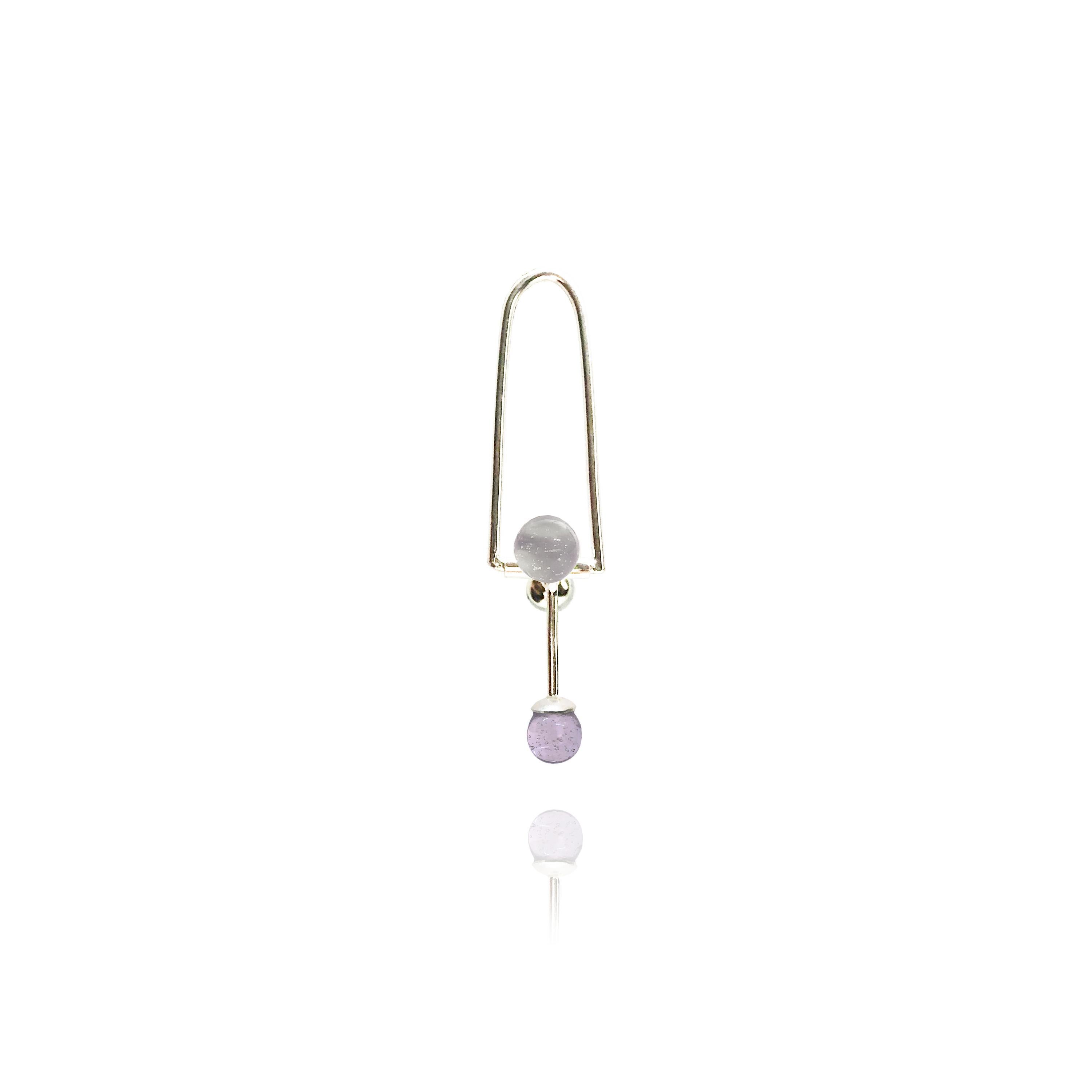 Borosilicate Glass and Sterling Silver
A single earring made to turn heads. Each glass orb is permanently fixed at each end of the three 
