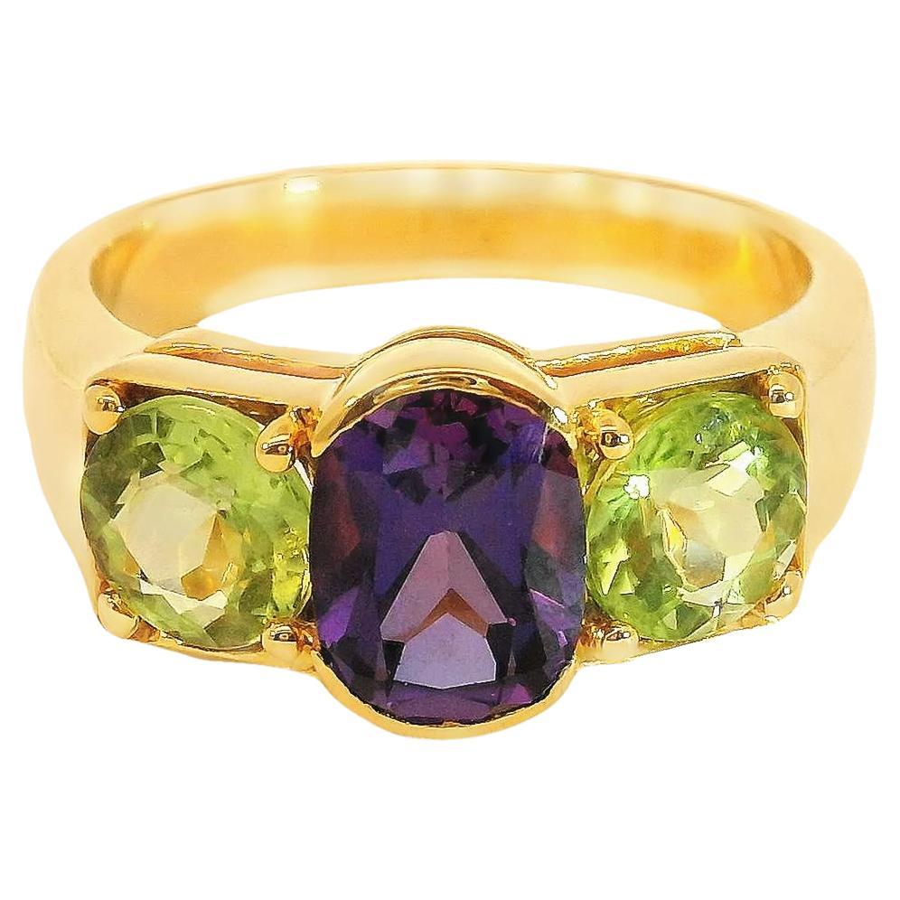 Three-stone 1.45 carat Oval Amethyst and Round Peridot Ring in 18K Yellow Gold For Sale