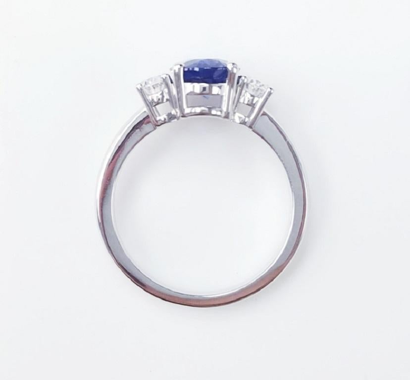 Contemporary Three-Stone 18 Karat White Gold Oval Cut Blue Sapphire and Diamond Ring