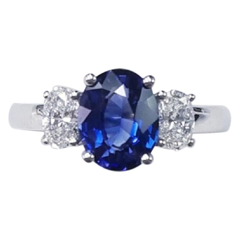 Three-Stone 18 Karat White Gold Oval Cut Blue Sapphire and Diamond Ring