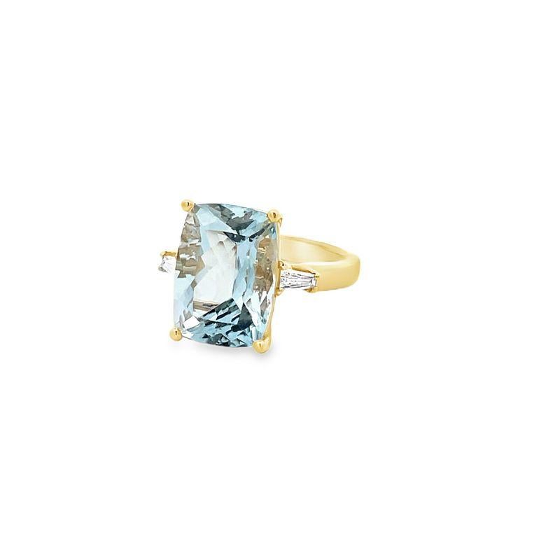 Prepare to be captivated by the stunning beauty of this three-stone ring! This ring features a striking cushion aquamarine, weighing an impressive 6.75 carats, which is complemented by two exquisite baguette diamonds weighing 0.20 carats, bringing