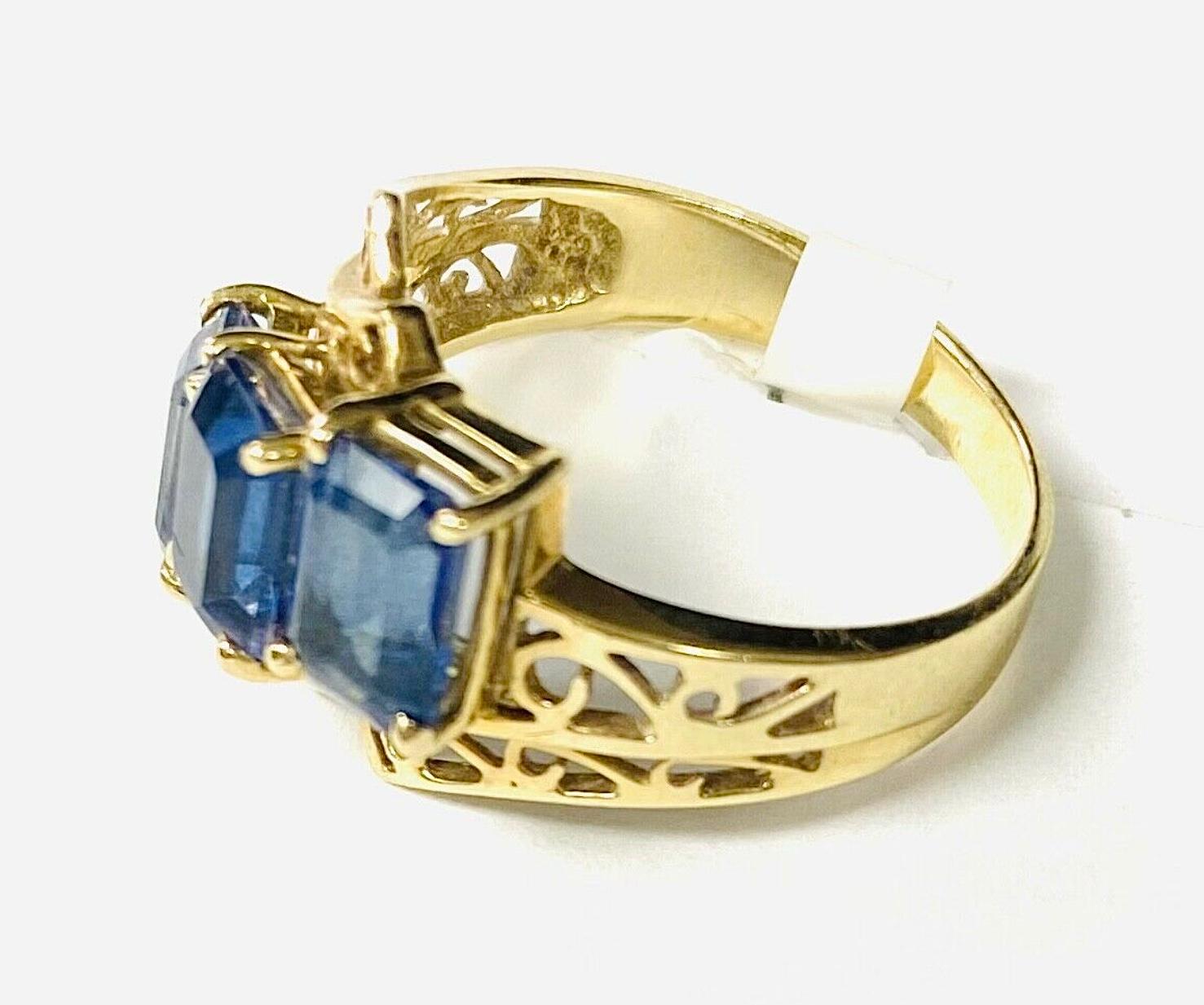 Modern Three Stone Blue Topaz 10K Yellow Gold Ring For Sale