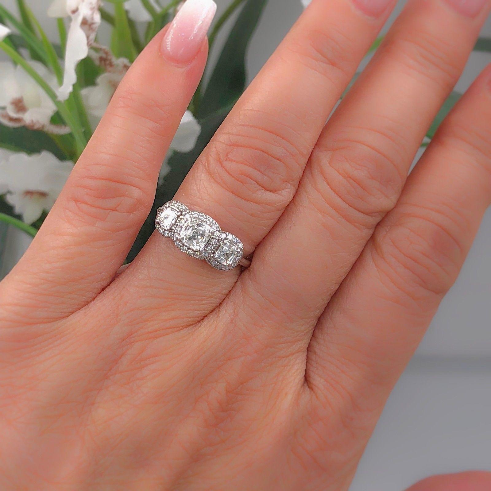 Three-Stone Cushion Brilliant Halo Design Engagement Ring

Metal:  14k White Gold
Size:  5.25 - sizable
Total Carat Weight:  1.17 tcw
Diamond Shape:  Cushion Brilliant 0.54 cts H - I / VS - SI
Side Stones:  2 Cushion Brilliant 0.44 tcw 
Accent