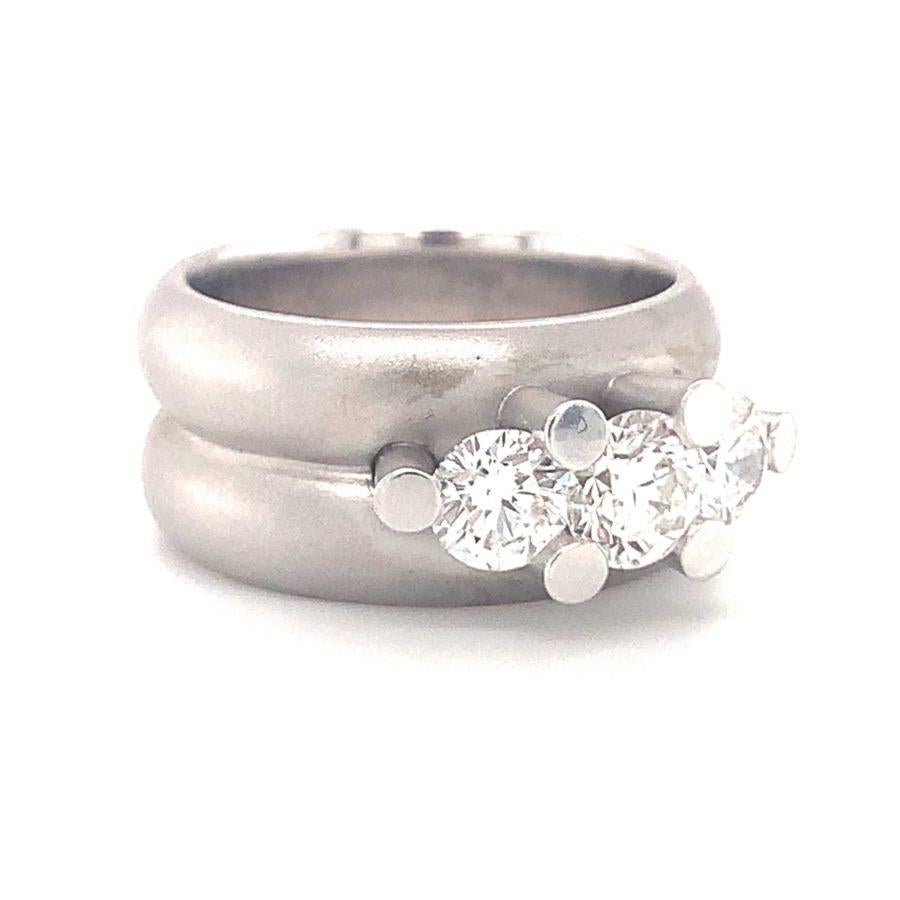 One three-stone diamond 14K white gold ring with a satin finish mount featuring 3 round brilliant cut diamonds totaling 1.28 ct. Circa 1980s.

Mighty, designer, substantial.

Additional information:
Metal: 14K white gold
Gemstone: Diamonds totaling