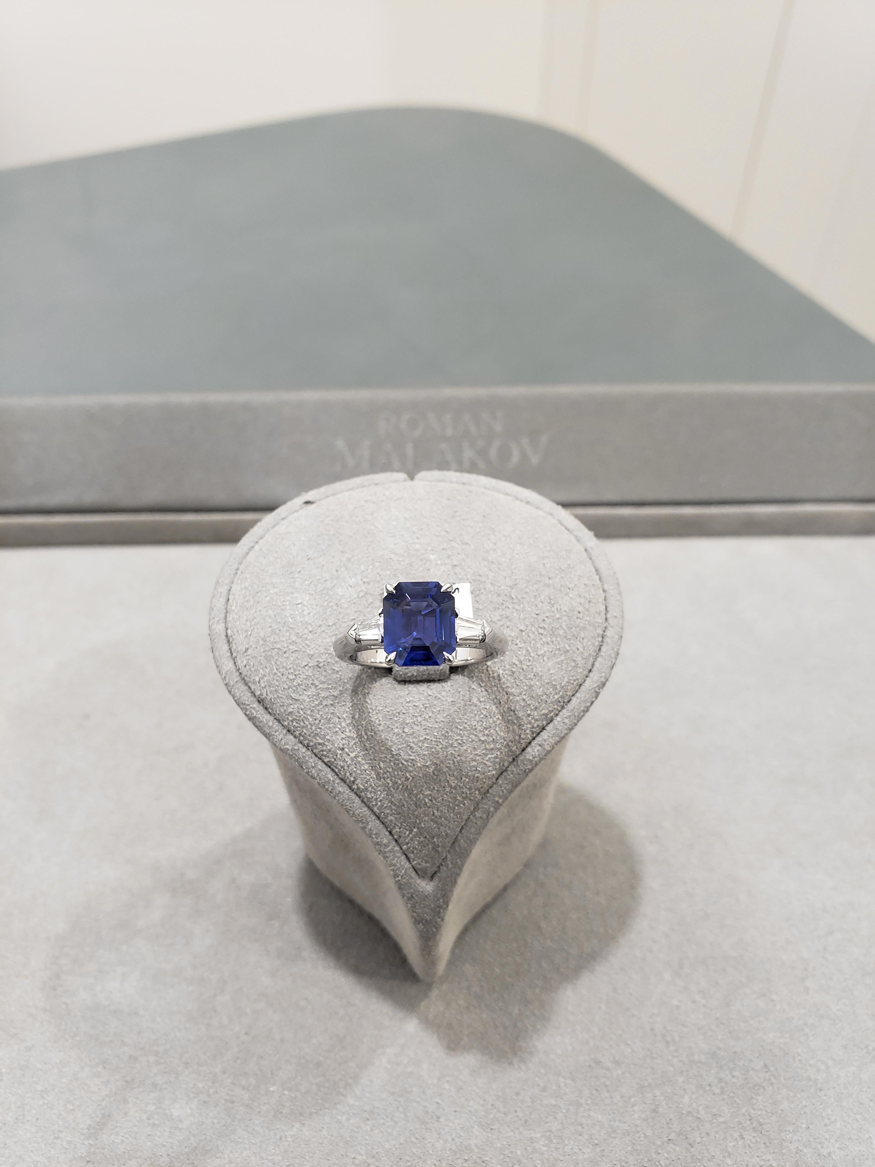 Showcases a 3.09 carat emerald cut blue sapphire, flanked by bullet-shaped diamonds on either side. Diamonds are approximately 0.31 carats, E color, VS clarity. Set in a platinum band. Sapphire certified as NO HEAT.

Style available in different