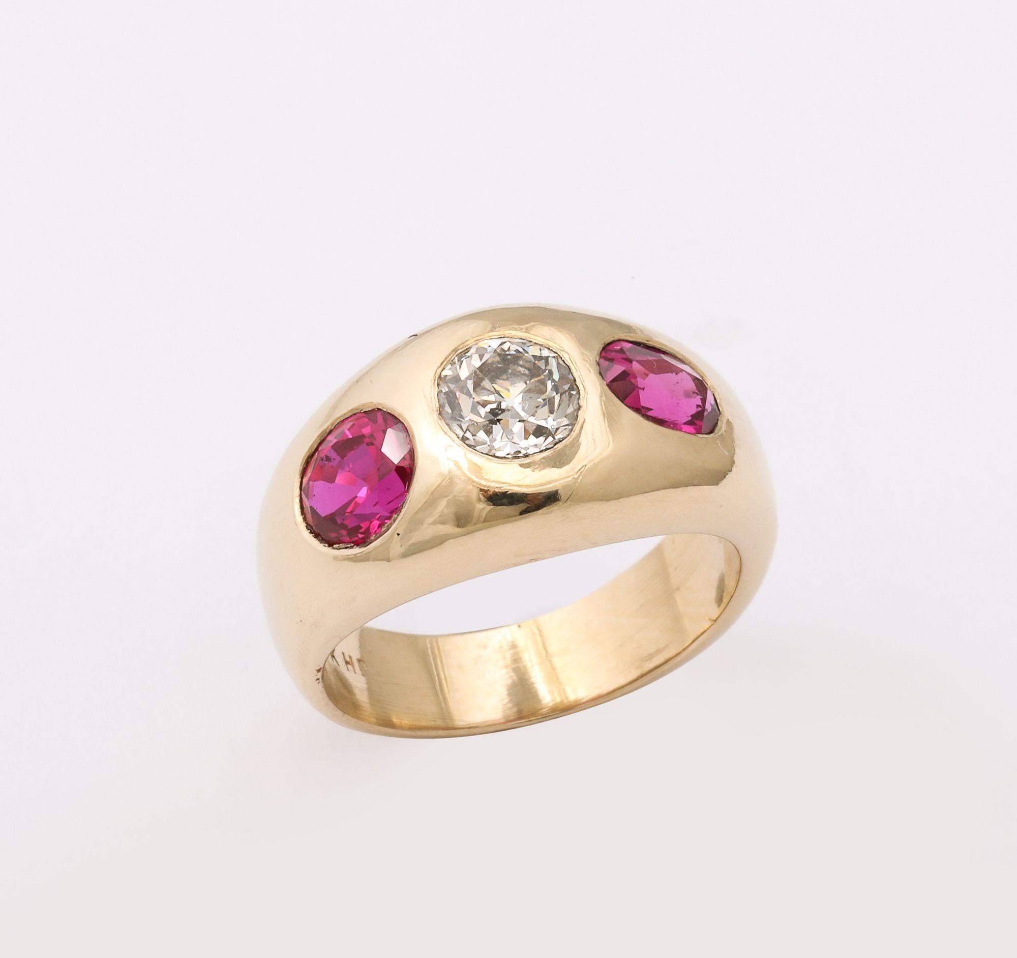 This is s rare Three Stone Diamond and Ruby Ring .with 80 Carat Old Mine cut diamond flanked by 2 exceptional, fine natural rubies which are 2 carats total weight. It is set in 14 k Gold. It looks great on it's own, but can also be stacked.