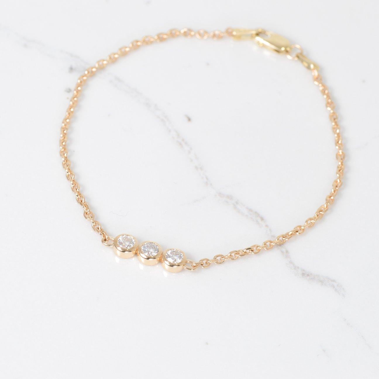 This diamond bracelet is truly beautiful! With three round diamonds in the center, totaling .45 carat and are set in 14k yellow gold. The bracelet measures 7 inches in length.