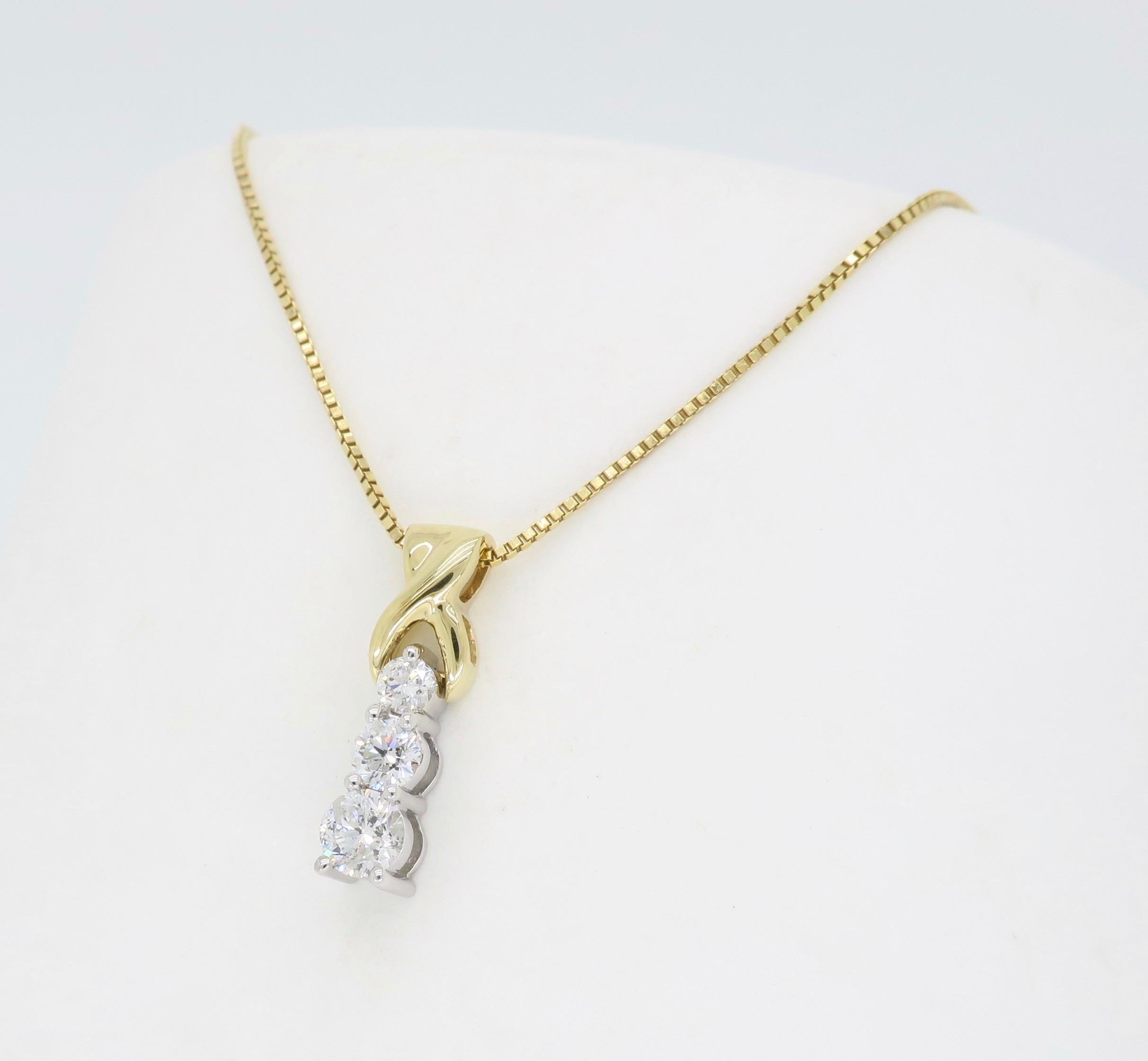 Three stone diamond drop pendant necklace crafted in two tone 14k yellow and white gold.

Diamond Carat Weight: Approximately .25CTW
Diamond Cut: Round Brilliant Diamonds
Color: Average G-I
Clarity: SI-I
Metal: 14K Yellow and White Gold
Chain