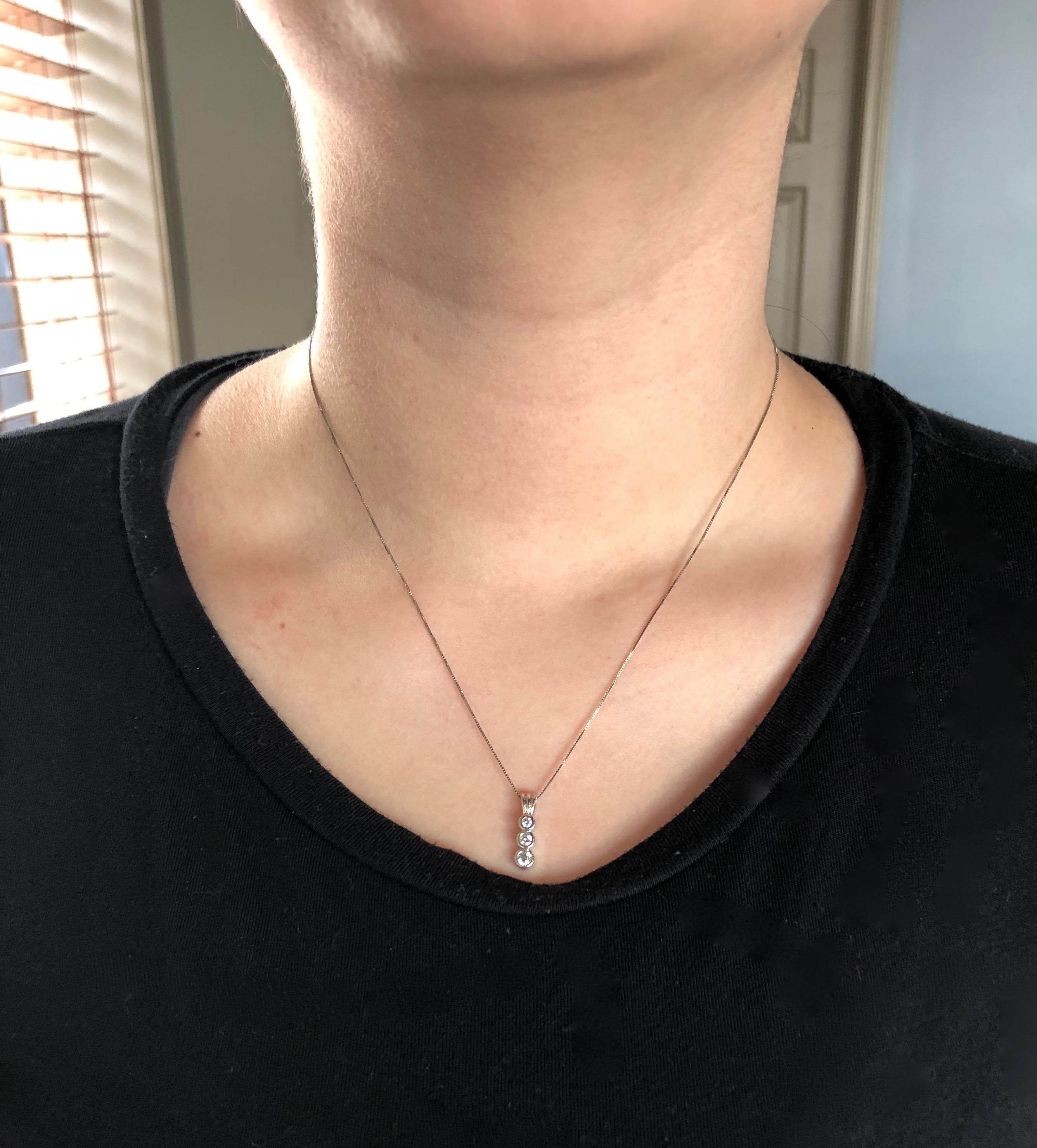 Diamond necklace featuring three stunning bezel set Round Brilliant Cut Diamonds set in 14K white gold.

Gemstone: Diamond
Gemstone Carat Weight: Approximately .25CTW
Diamond Cut: Round Brilliant 
Average Diamond Color: G-I
Average Diamond Clarity: