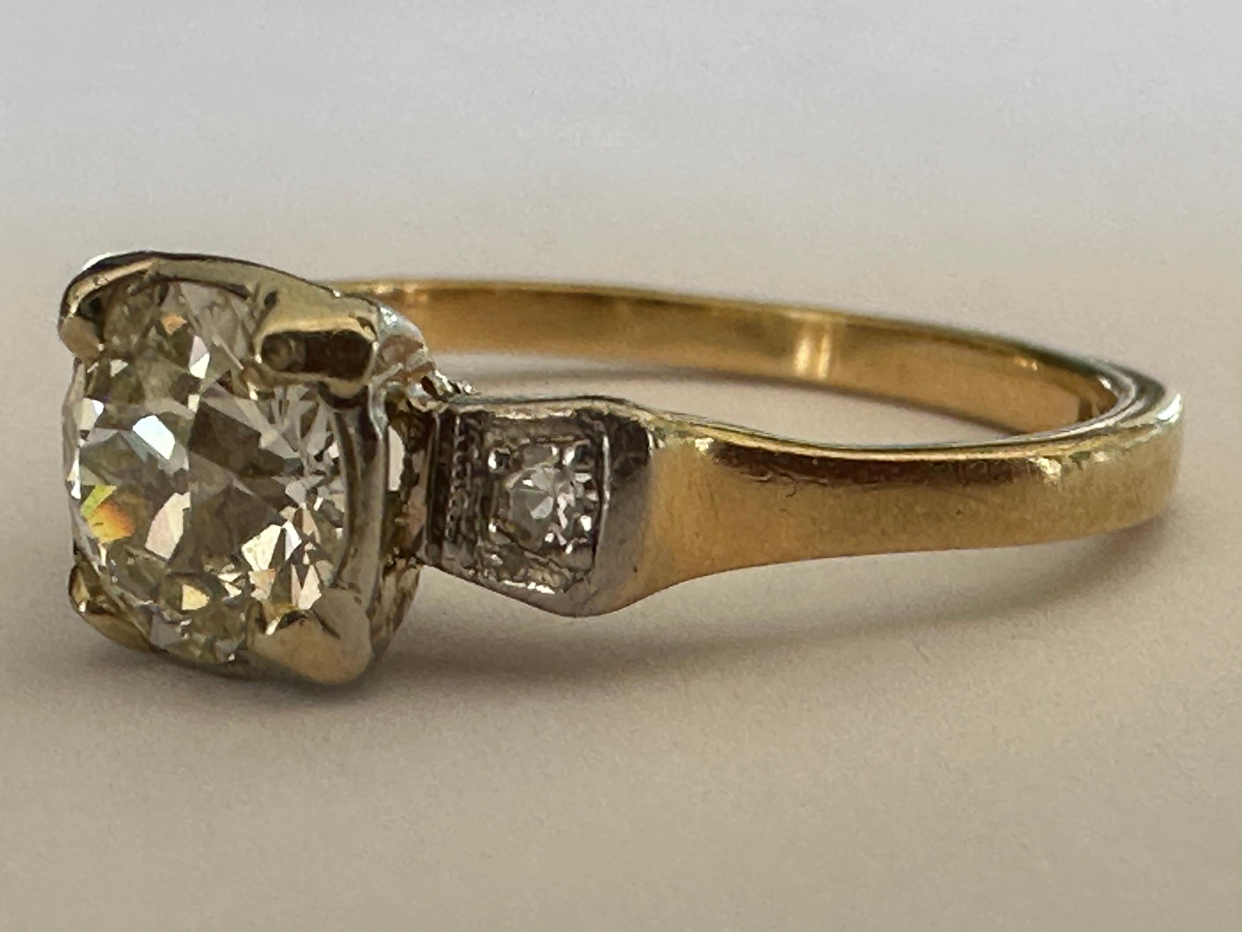 Crafted in the 1940s, this classic three-stone engagement ring features a bold Old European cut diamond center stone measuring approximately 1.00 carat closely set between two single cut diamonds. Set in 14K white and yellow gold. 
